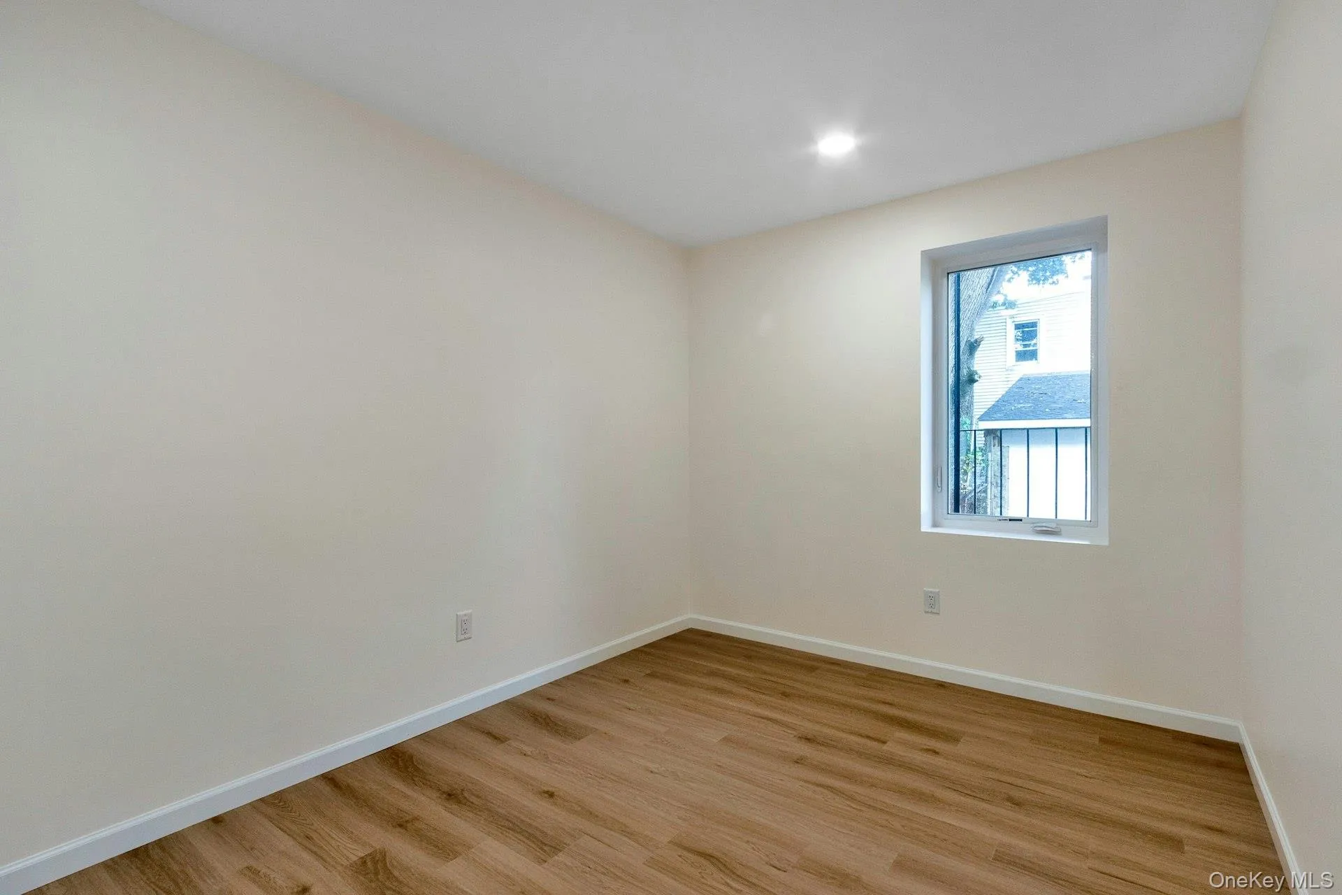 Unfurnished room with light wood finished floors and recessed lighting Unfurnished room with light wood finished floors and recessed lighting