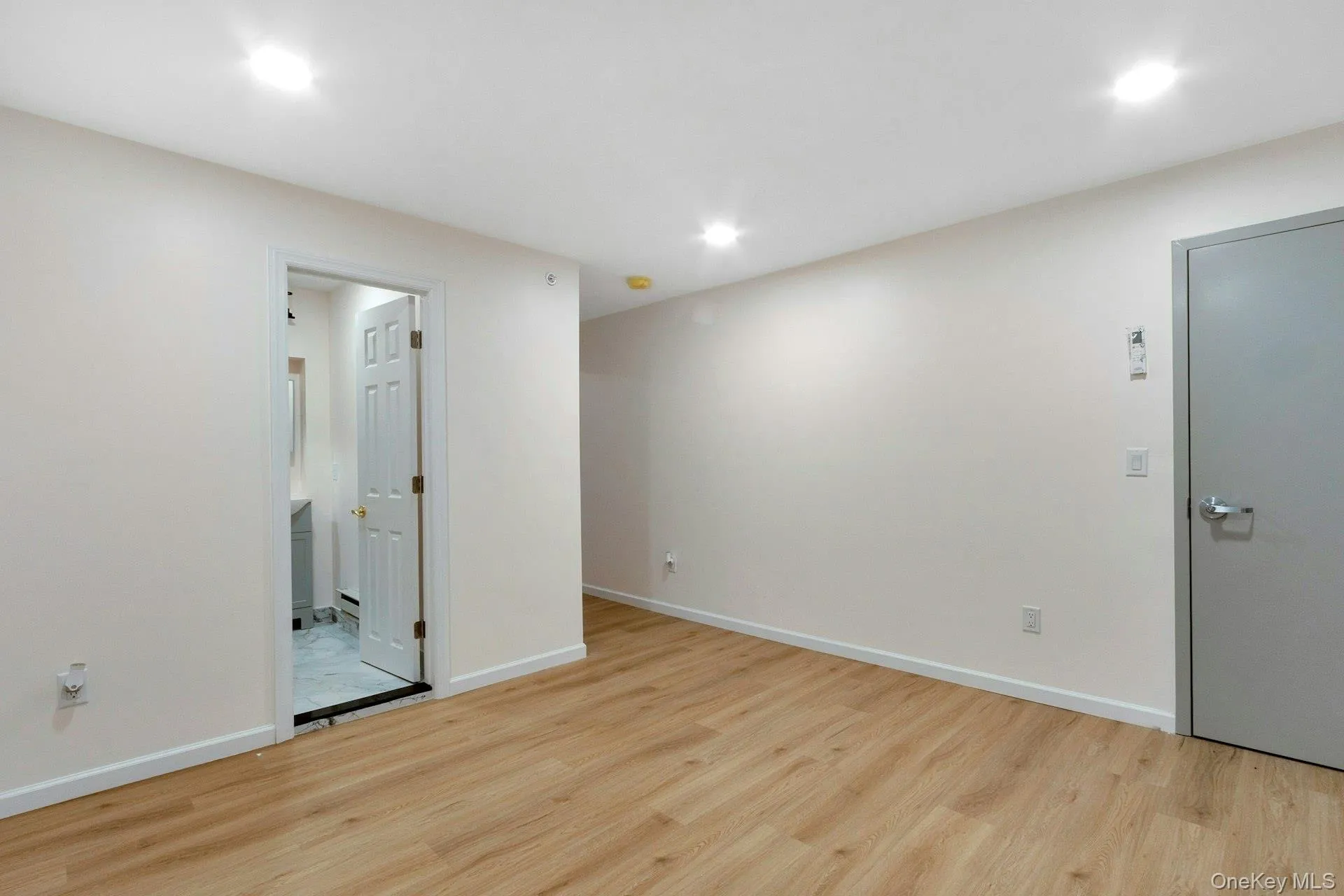 Empty room featuring light wood-style flooring and recessed lighting Empty room featuring light wood-style flooring and recessed lighting