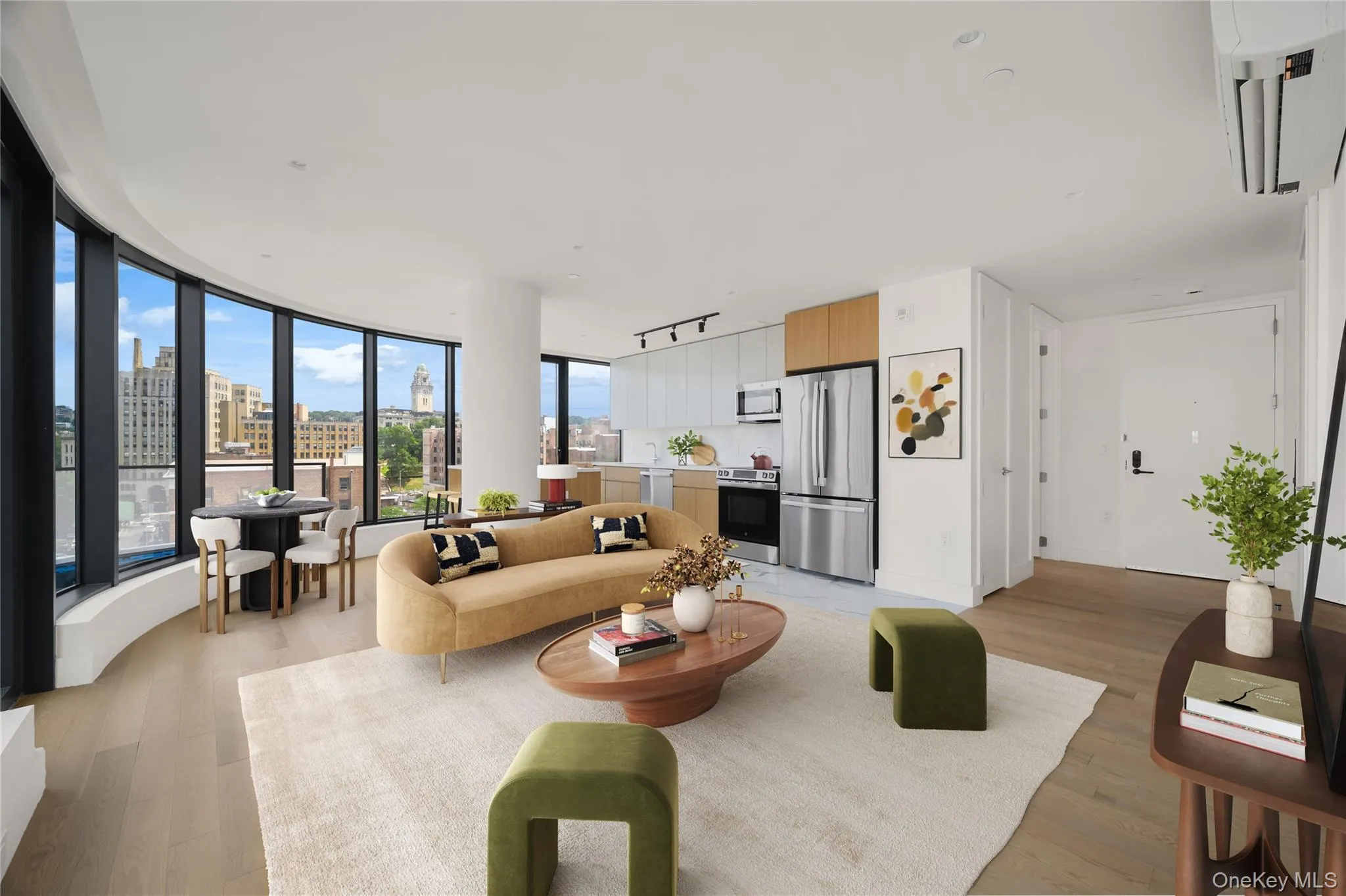 Living area featuring light wood-style flooring, a city view, and floor to ceiling windows Living area featuring light wood-style flooring, a city view, and floor to ceiling windows