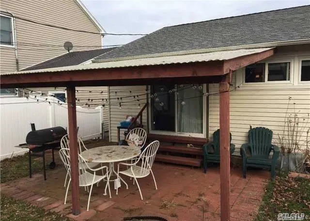 View of patio / terrace featuring grilling area and outdoor dining space View of patio / terrace featuring grilling area and outdoor dining space