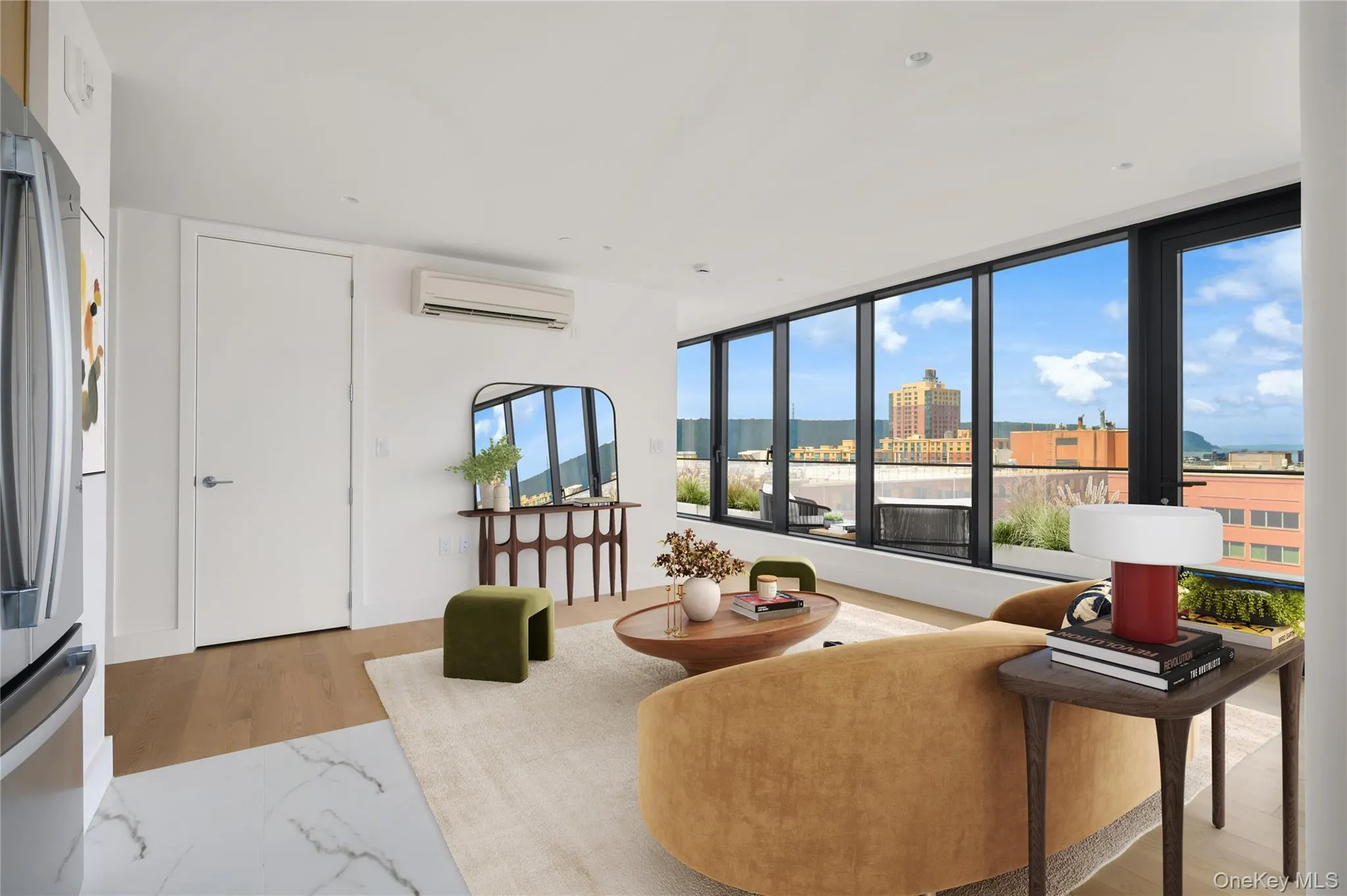 Living area with light wood-type flooring and an AC wall unit Living area with light wood-type flooring and an AC wall unit