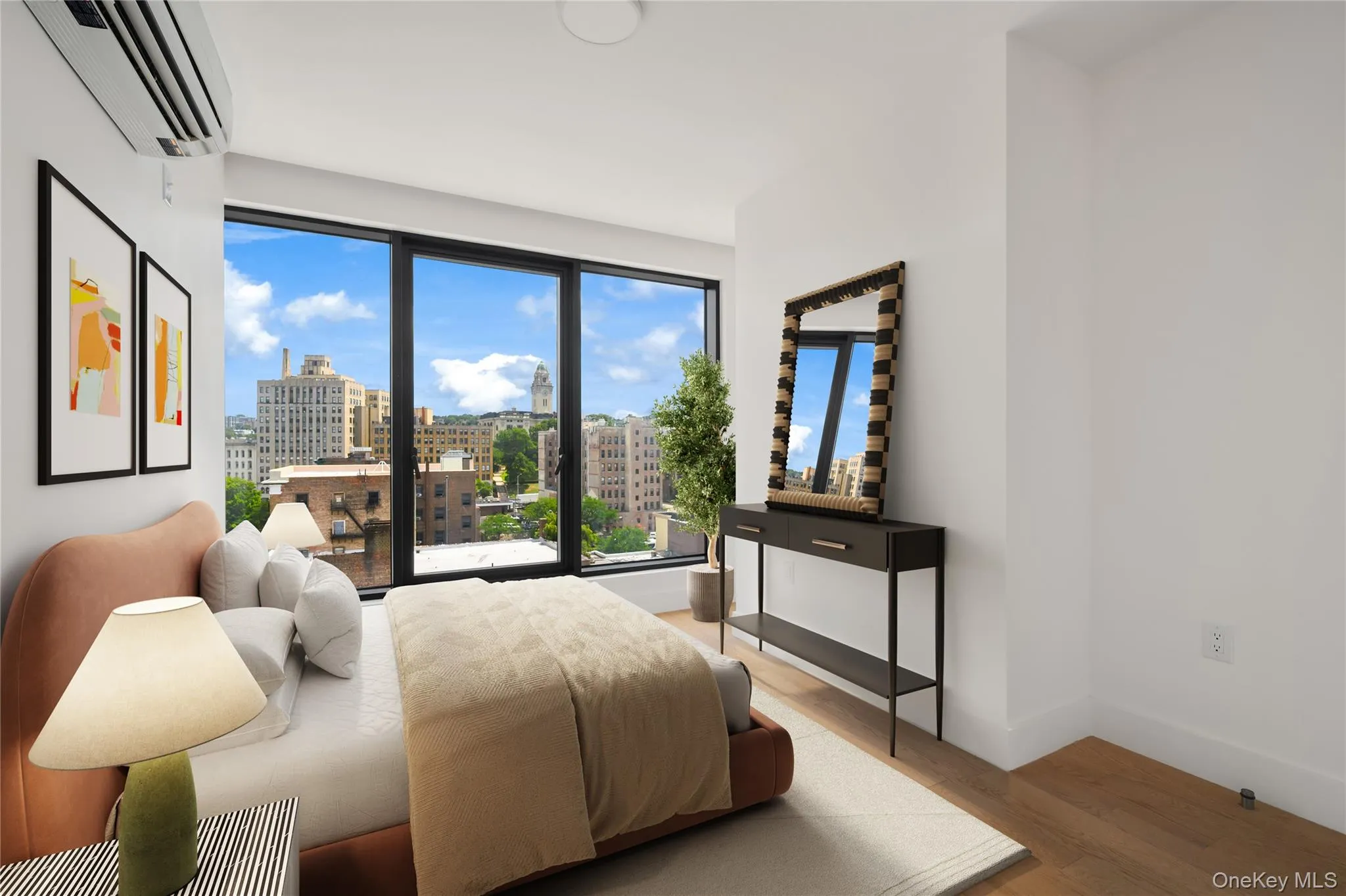 Bedroom with a view of city, light wood-type flooring, and an AC wall unit Bedroom with a view of city, light wood-type flooring, and an AC wall unit