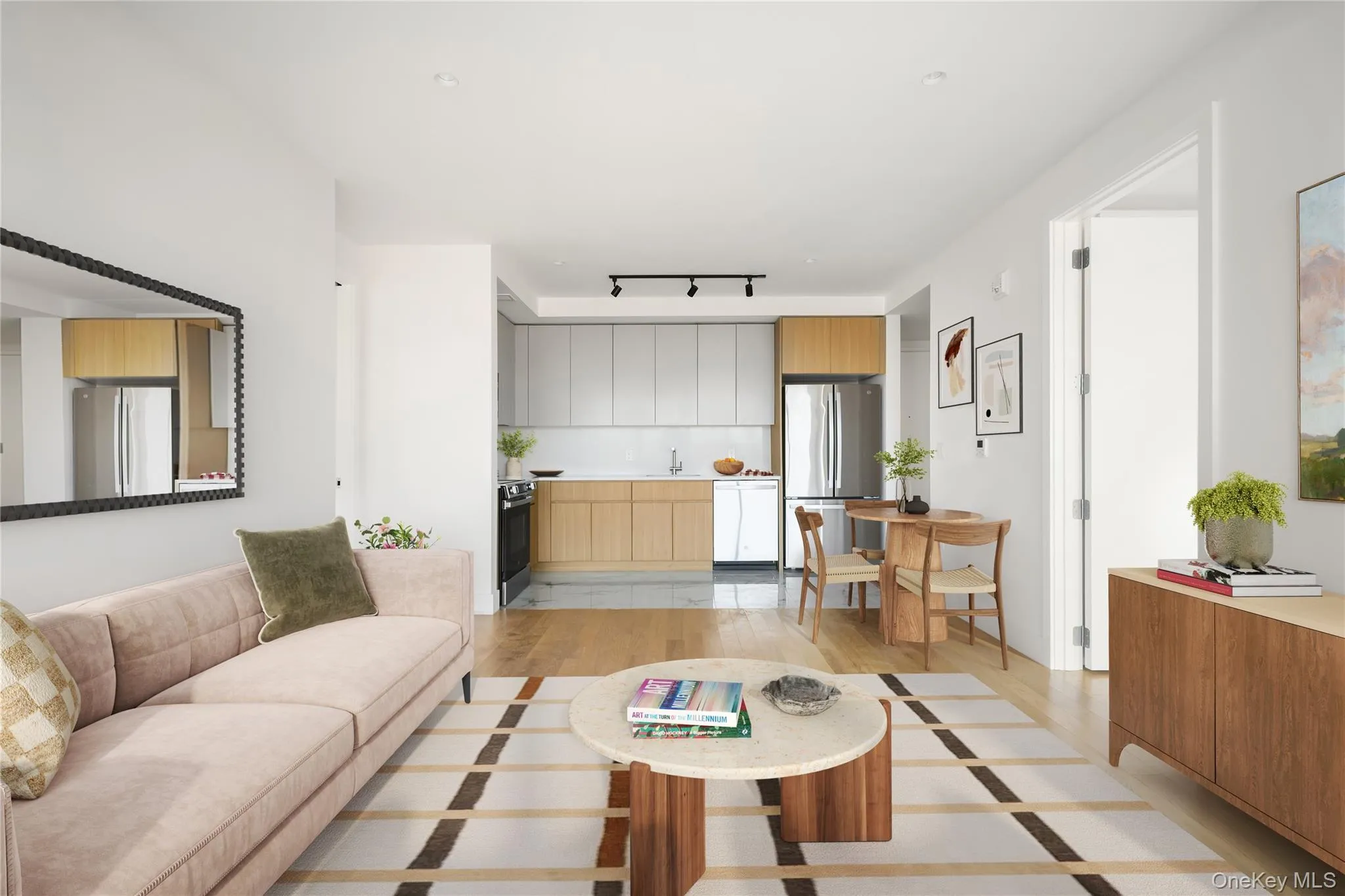 Living room featuring rail lighting and light wood-type flooring Living room featuring rail lighting and light wood-type flooring