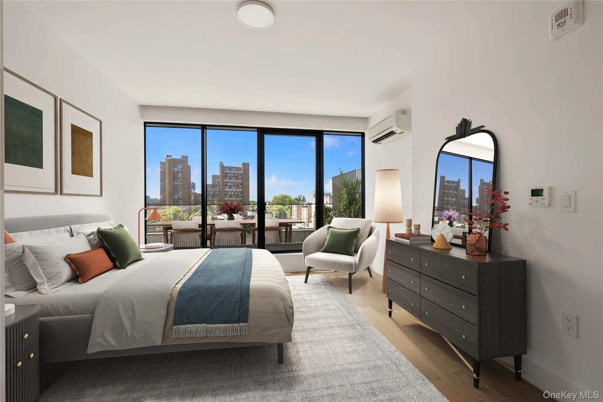 Bedroom featuring a skyline view, wood finished floors, and an AC wall unit Bedroom featuring a skyline view, wood finished floors, and an AC wall unit