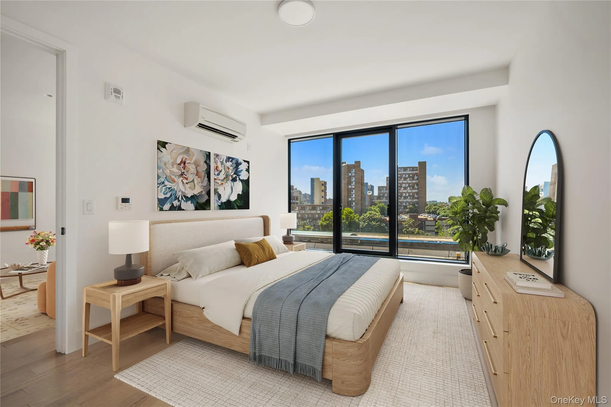 Bedroom featuring a view of skyline, light wood-style flooring, and an AC wall unit Bedroom featuring a view of skyline, light wood-style flooring, and an AC wall unit