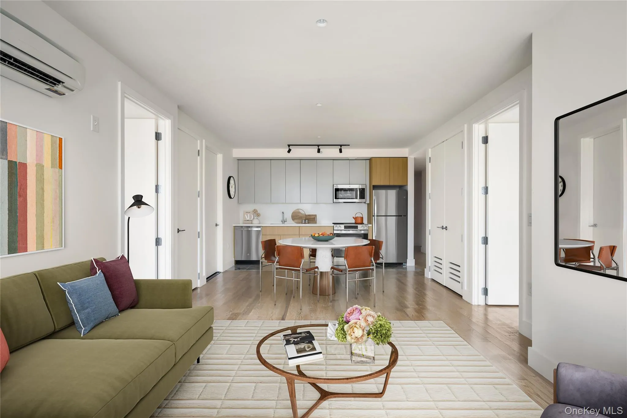 Living room with light wood-style floors and a wall unit AC Living room with light wood-style floors and a wall unit AC