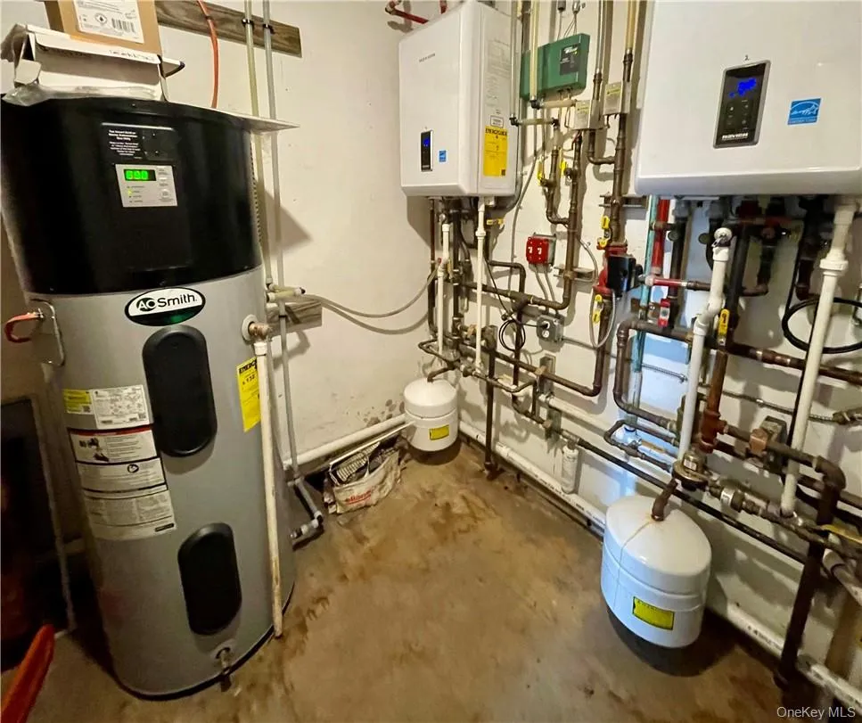 Utilities featuring tankless water heater and hybrid water heater Utilities featuring tankless water heater and hybrid water heater