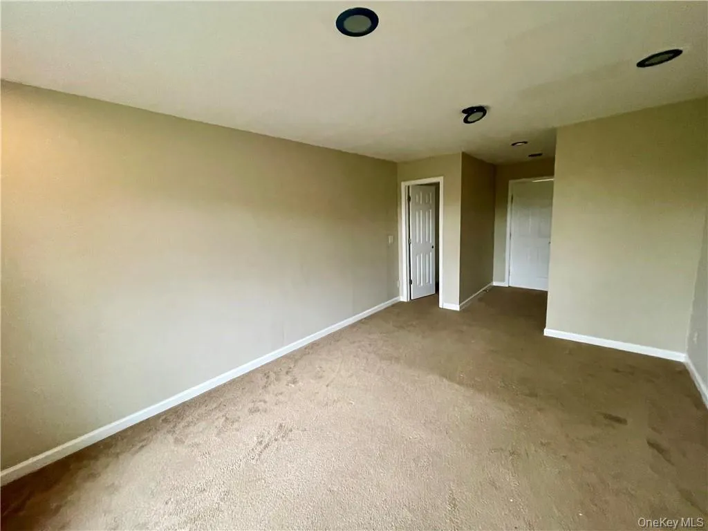Unfurnished bedroom featuring carpet Unfurnished bedroom featuring carpet