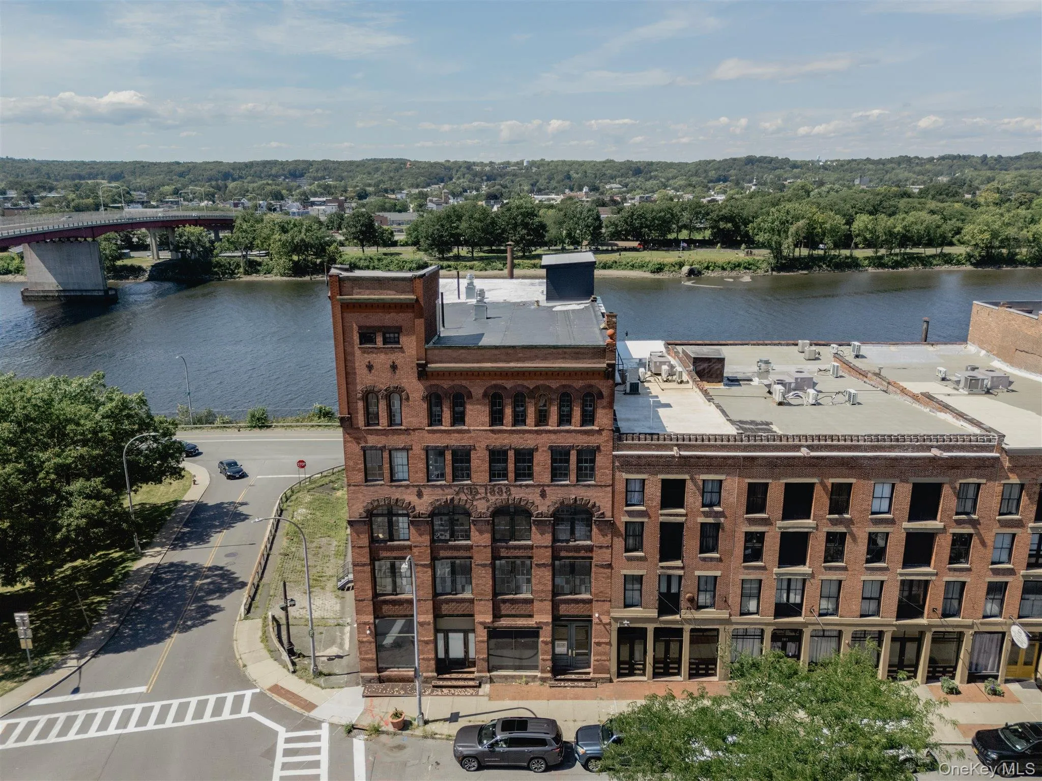 Bird's eye view of a nearby body of water and a notable bridge Bird's eye view of a nearby body of water and a notable bridge