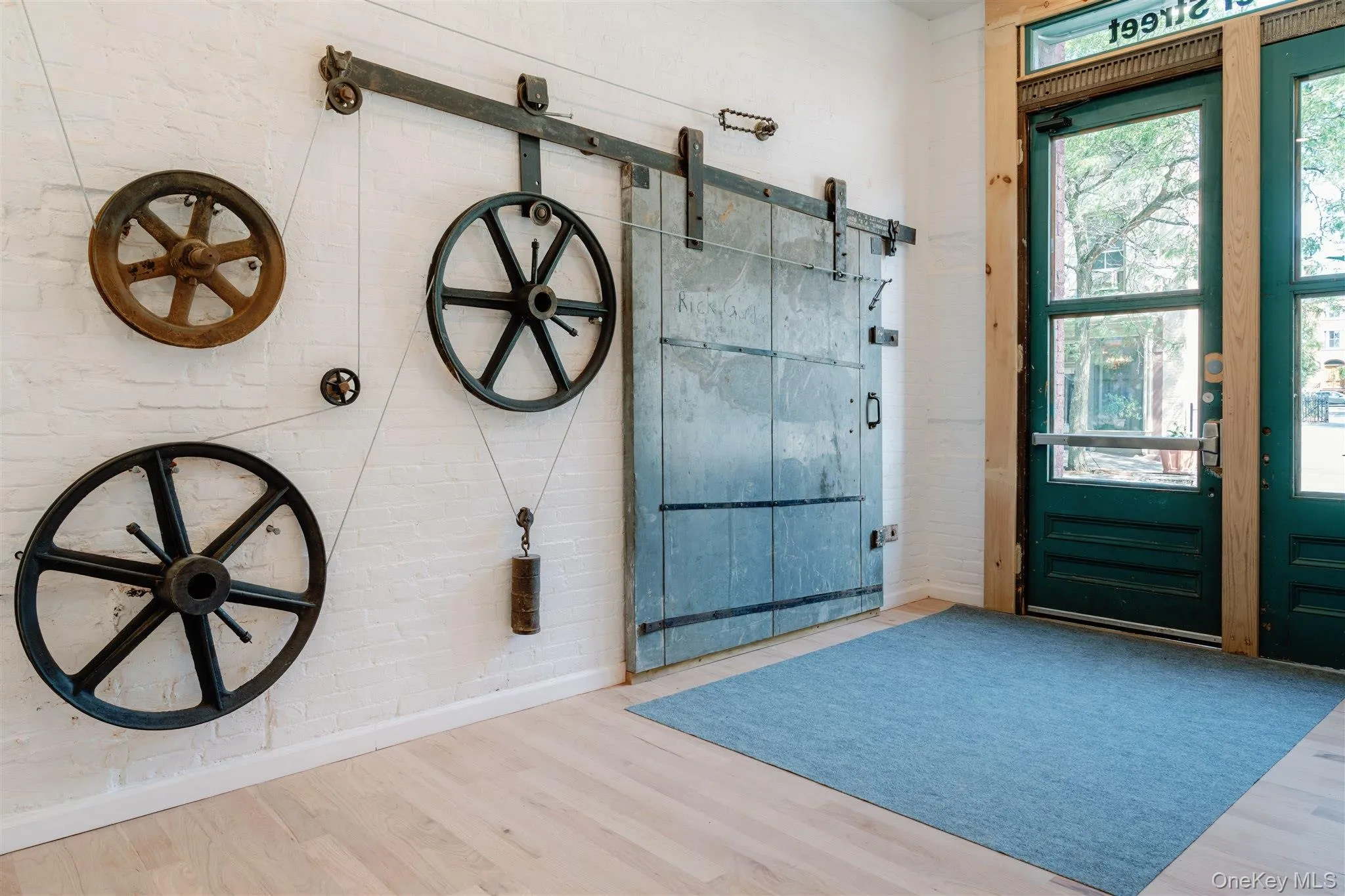 Entryway featuring a barn door, plenty of natural light, and wood finished floors Entryway featuring a barn door, plenty of natural light, and wood finished floors