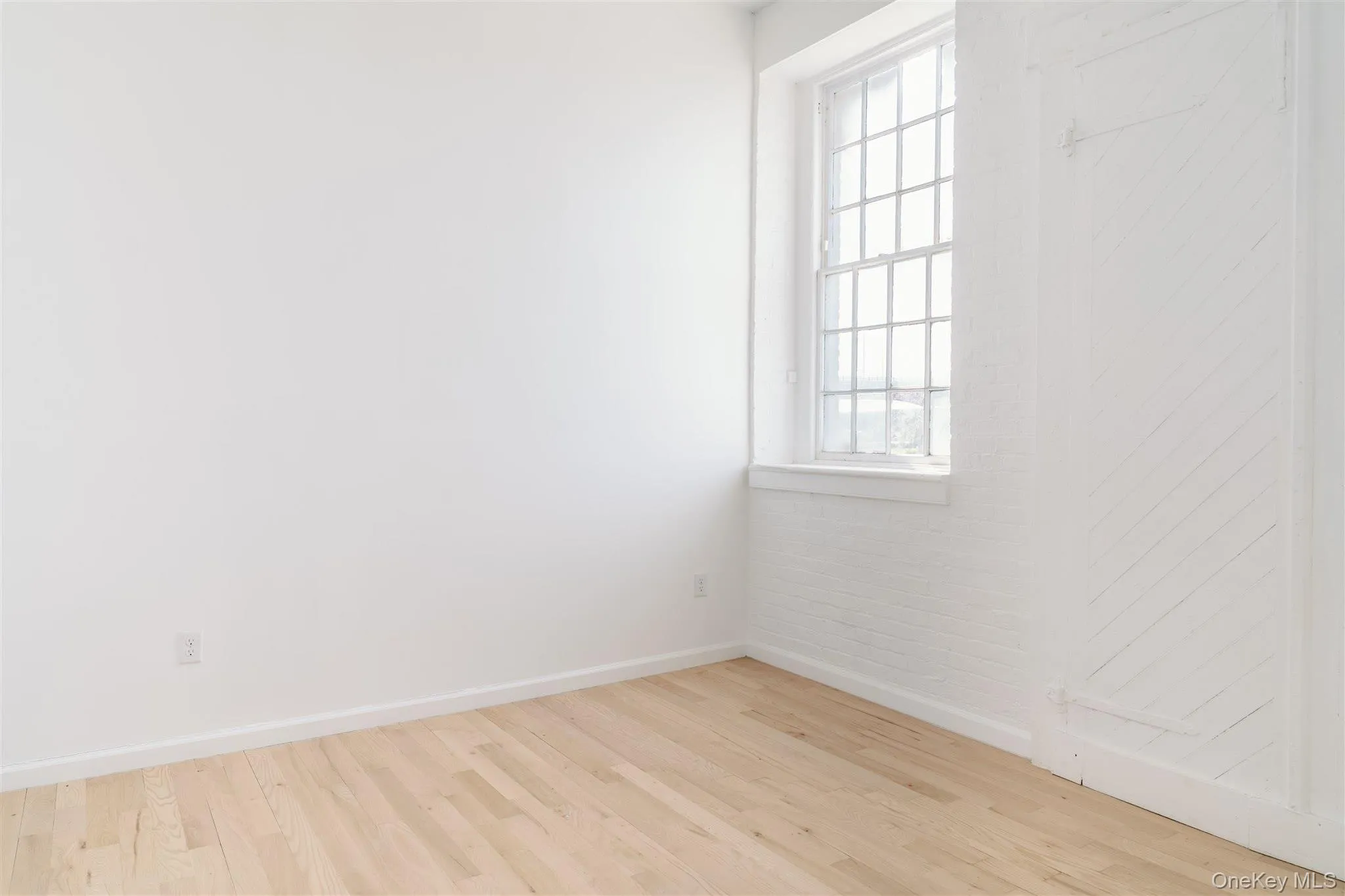 Spare room with baseboards and wood finished floors Spare room with baseboards and wood finished floors