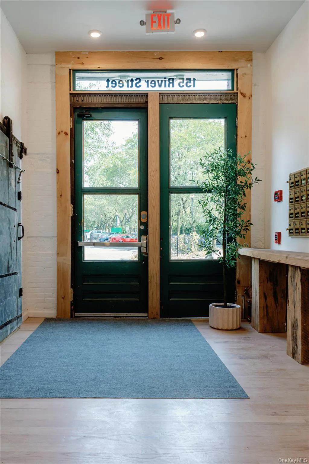 Doorway to outside with wood finished floors Doorway to outside with wood finished floors