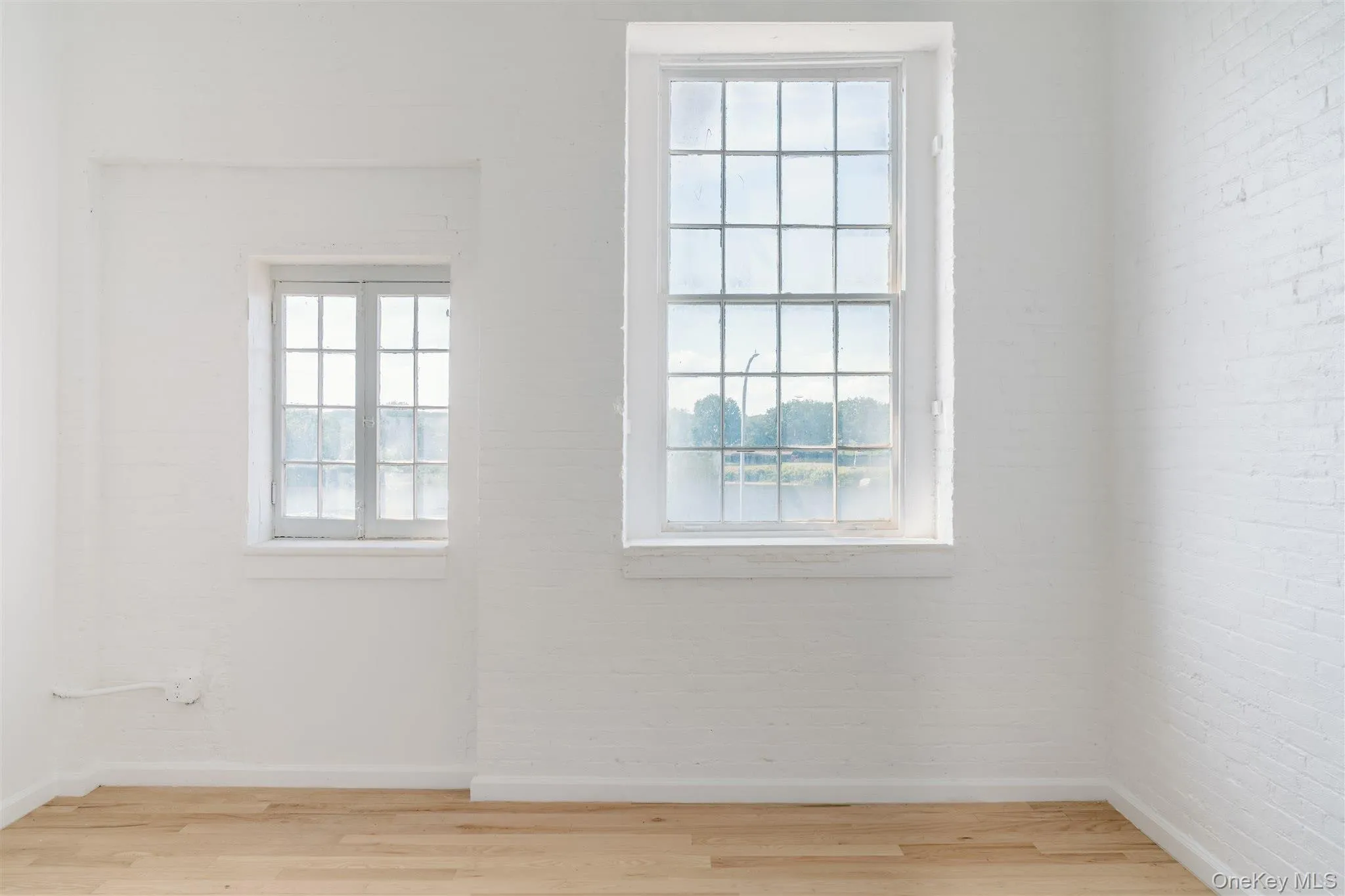 Unfurnished room featuring wood finished floors and baseboards Unfurnished room featuring wood finished floors and baseboards