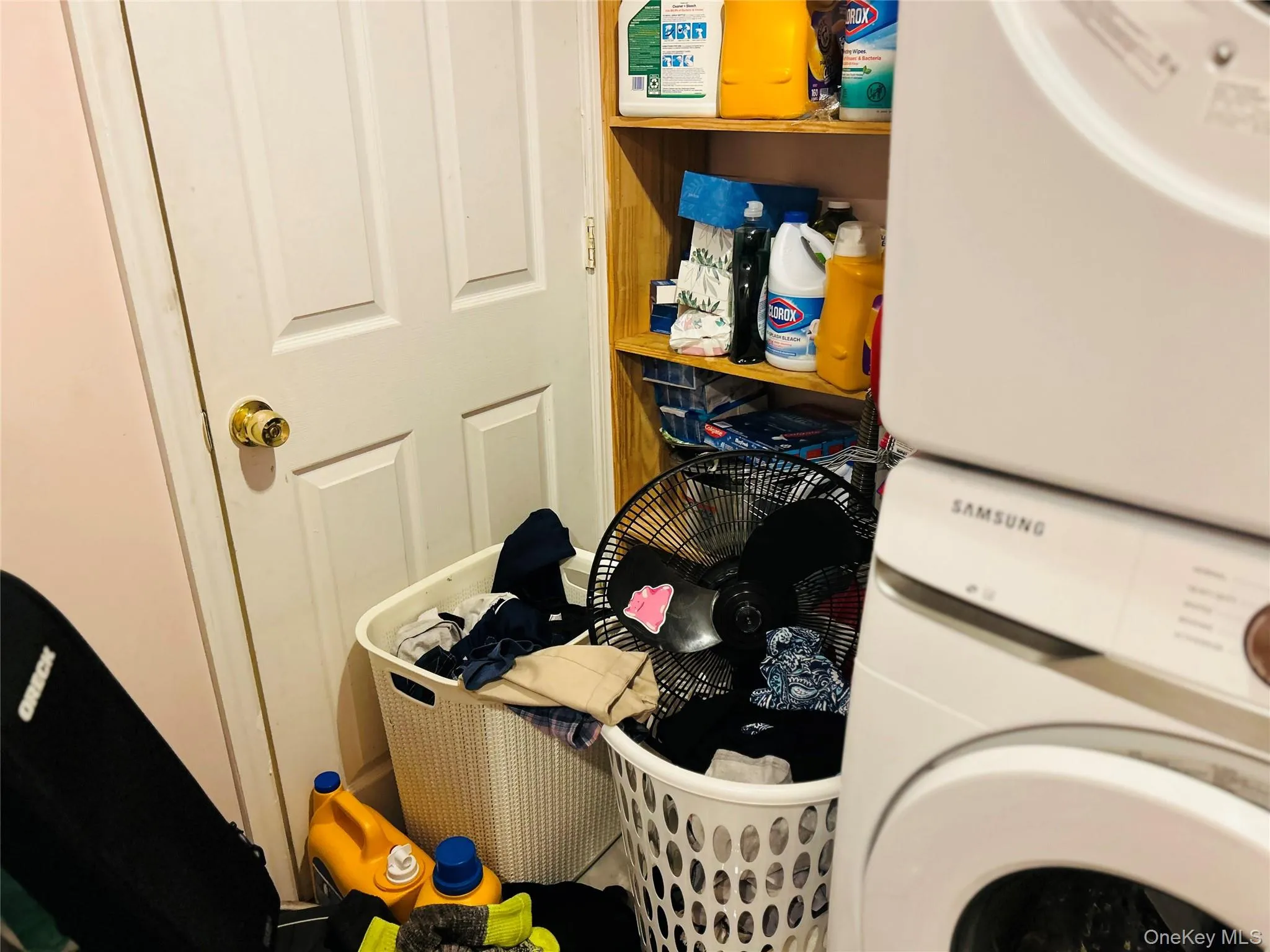 Laundry room featuring stacked washer / dryer Laundry room featuring stacked washer / dryer