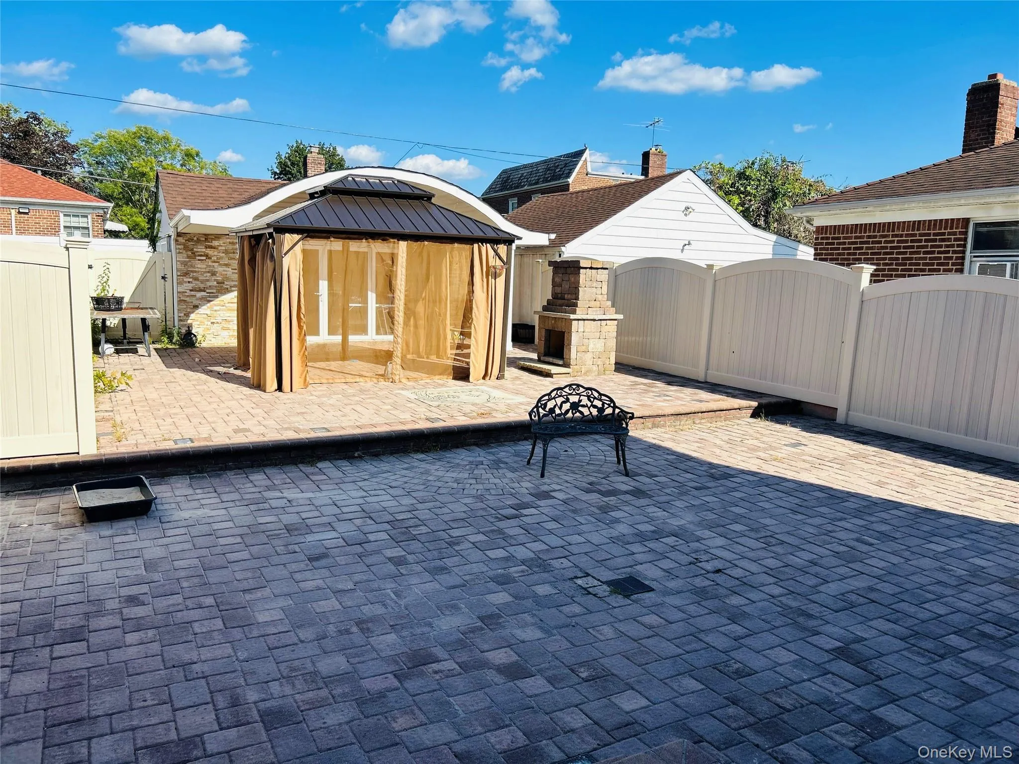 View of patio / terrace with a gate, a gazebo, and an outbuilding View of patio / terrace with a gate, a gazebo, and an outbuilding