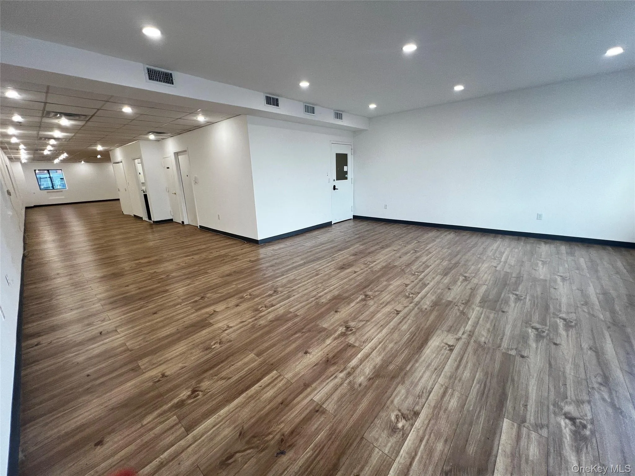 Spare room with wood finished floors and recessed lighting Spare room with wood finished floors and recessed lighting