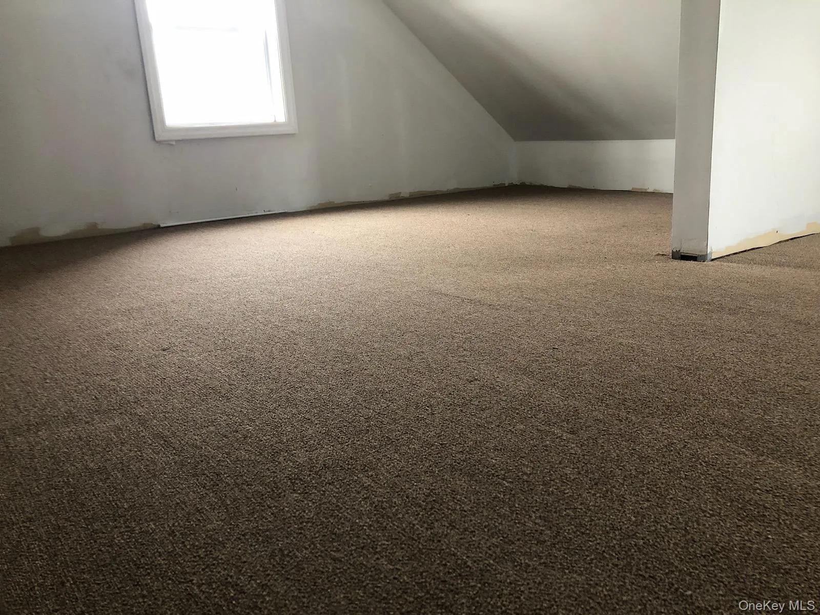 Bonus room with light colored carpet and lofted ceiling Bonus room with light colored carpet and lofted ceiling