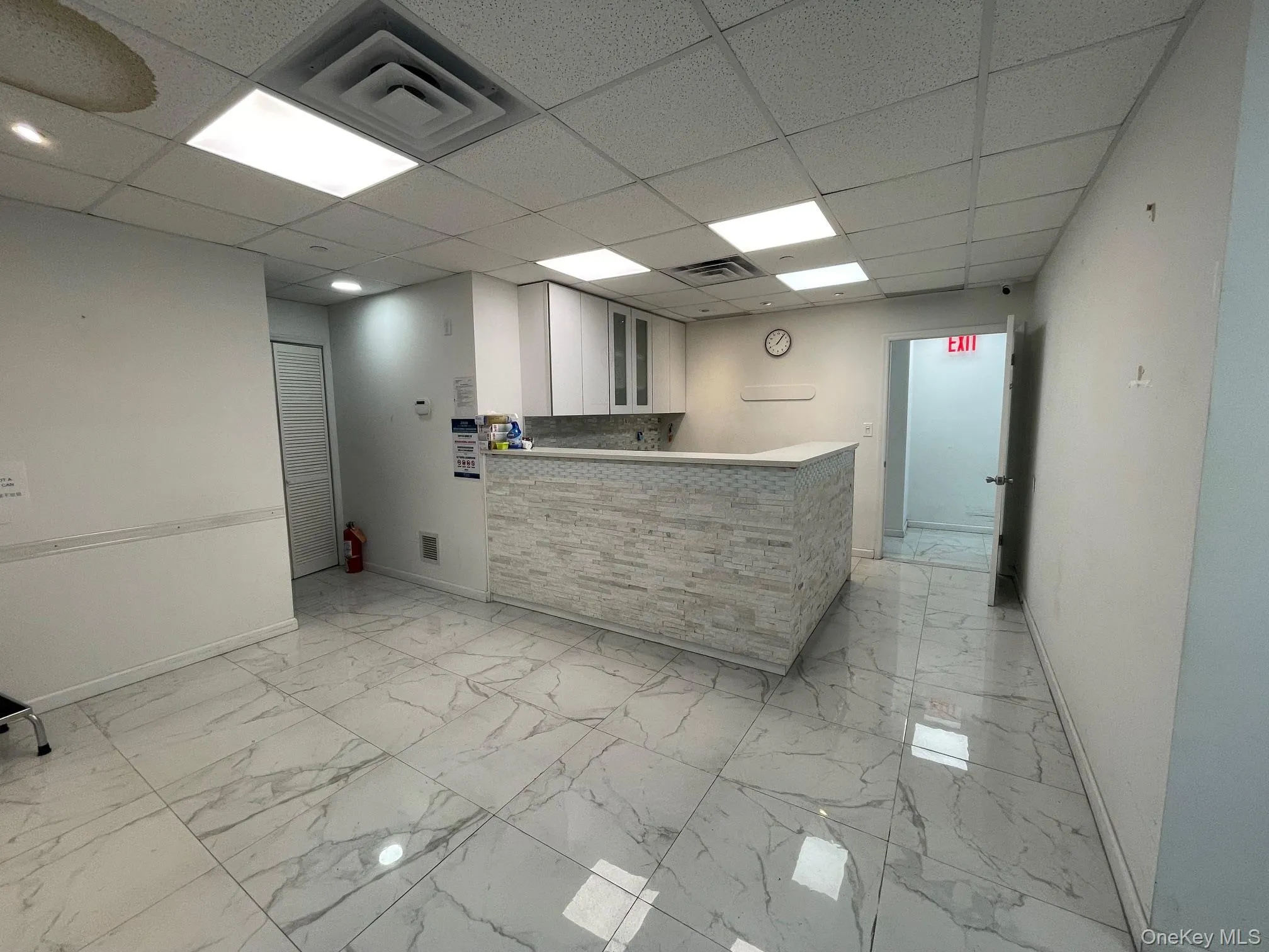 Reception area featuring a drop ceiling Reception area featuring a drop ceiling