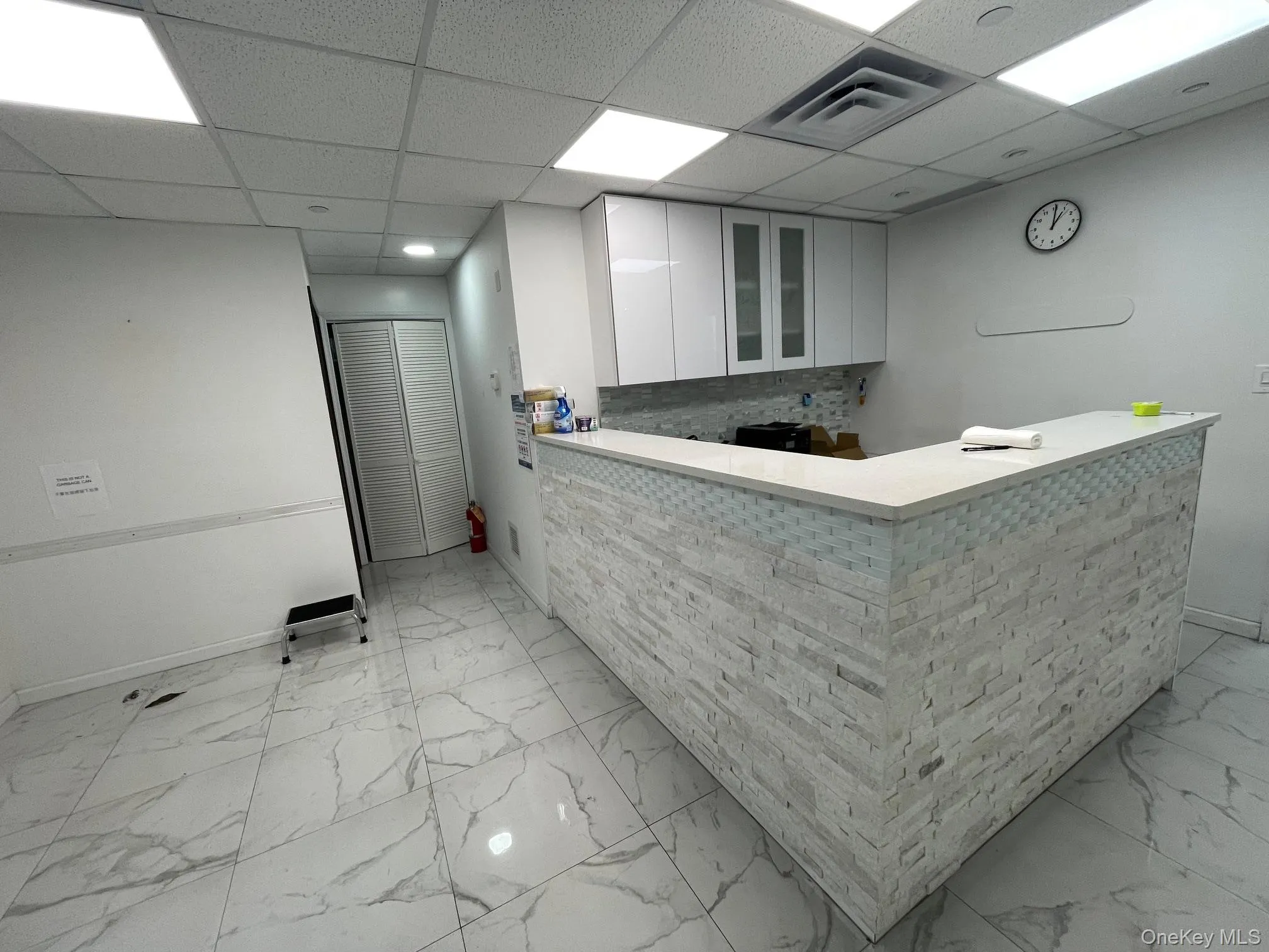 Welcome area featuring a drop ceiling Welcome area featuring a drop ceiling
