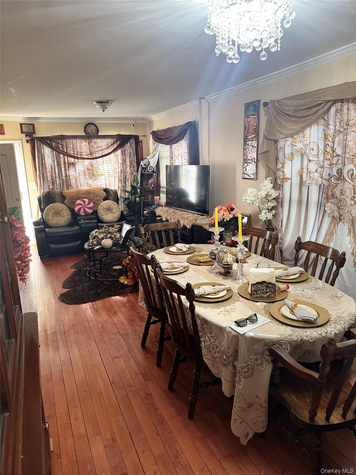 Dining room featuring hardwood / wood-style flooring, crown molding, and a chandelier Dining room featuring hardwood / wood-style flooring, crown molding, and a chandelier