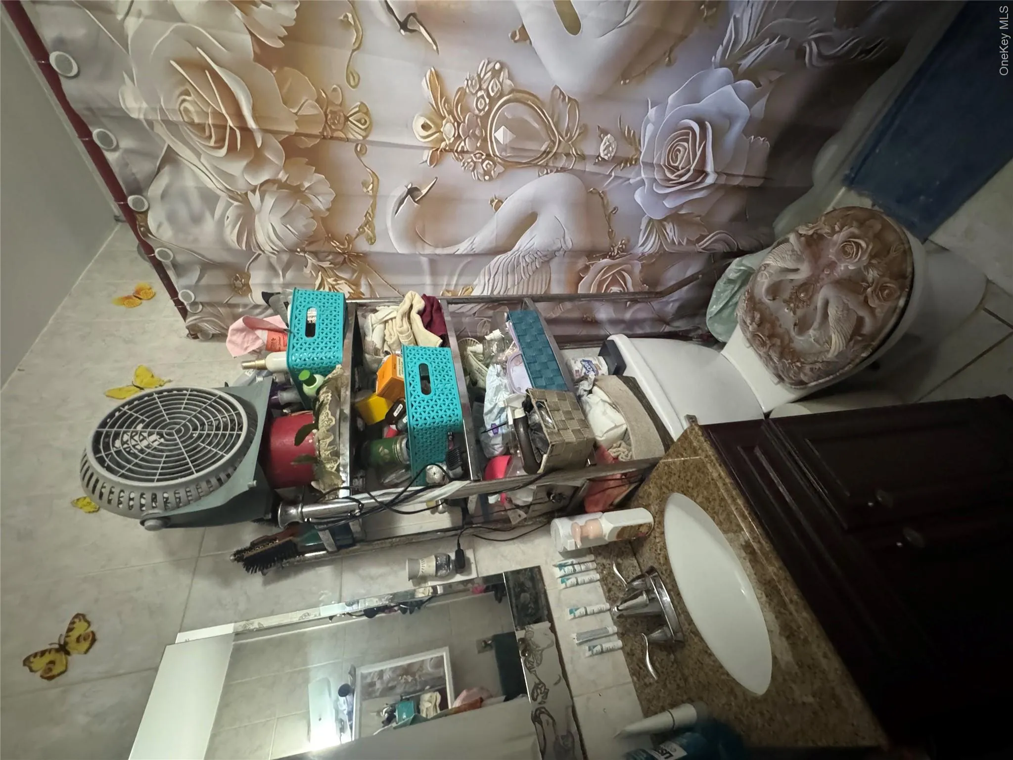 Bathroom with vanity, tile patterned floors, and tile walls Bathroom with vanity, tile patterned floors, and tile walls