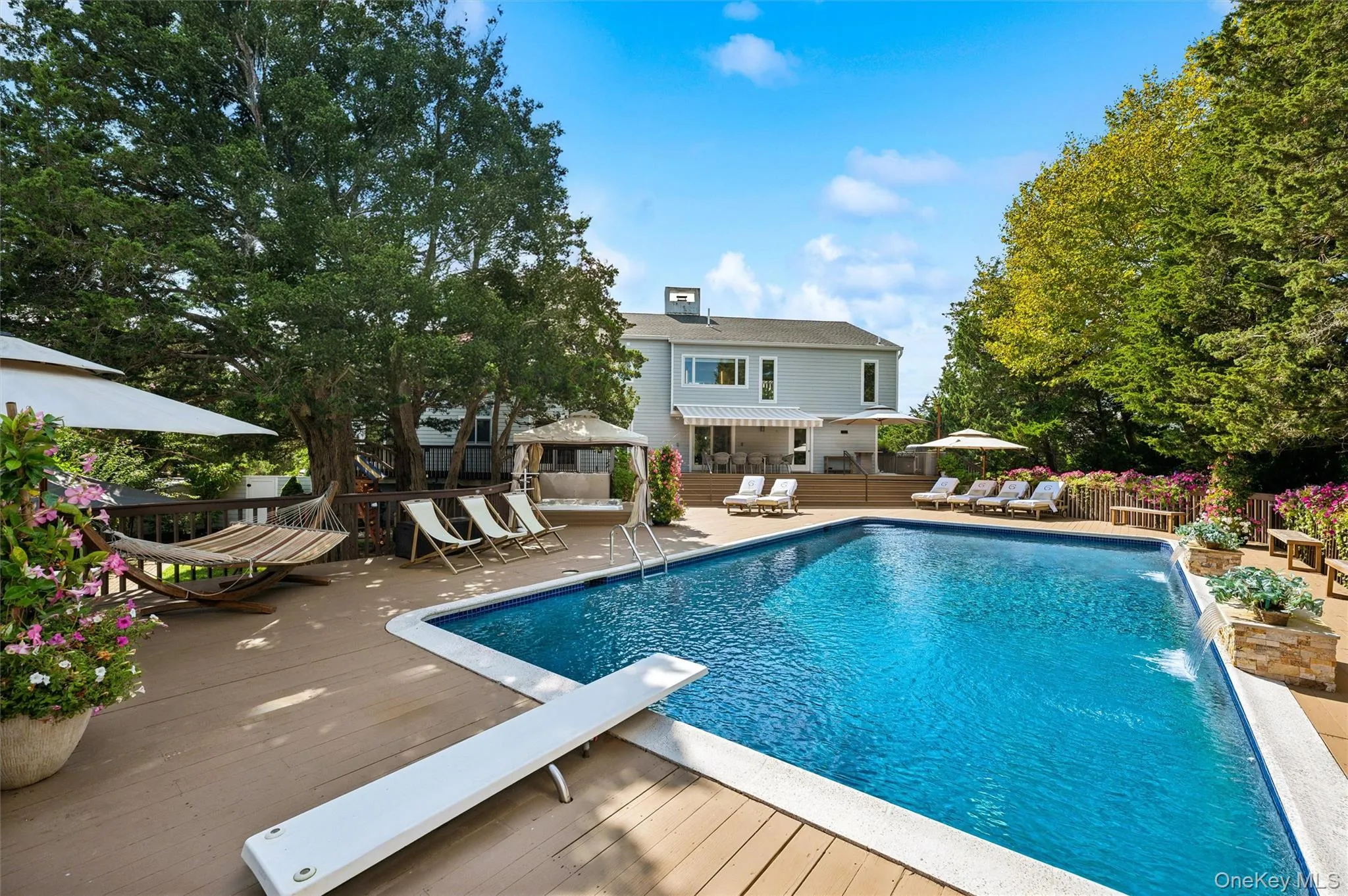 View of pool featuring a patio area, a diving board, a gazebo, and a wooden deck View of pool featuring a patio area, a diving board, a gazebo, and a wooden deck