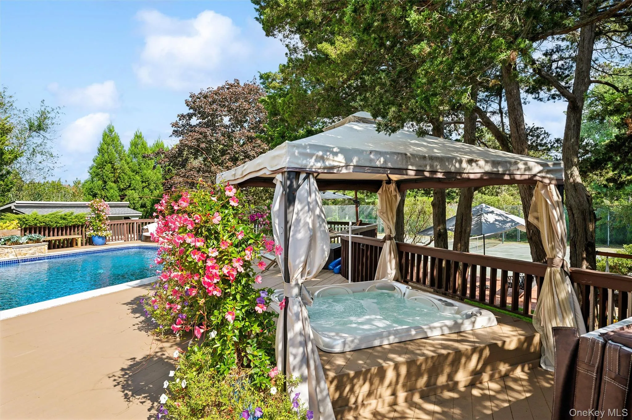 Wooden deck with a gazebo and an outdoor hot tub Wooden deck with a gazebo and an outdoor hot tub