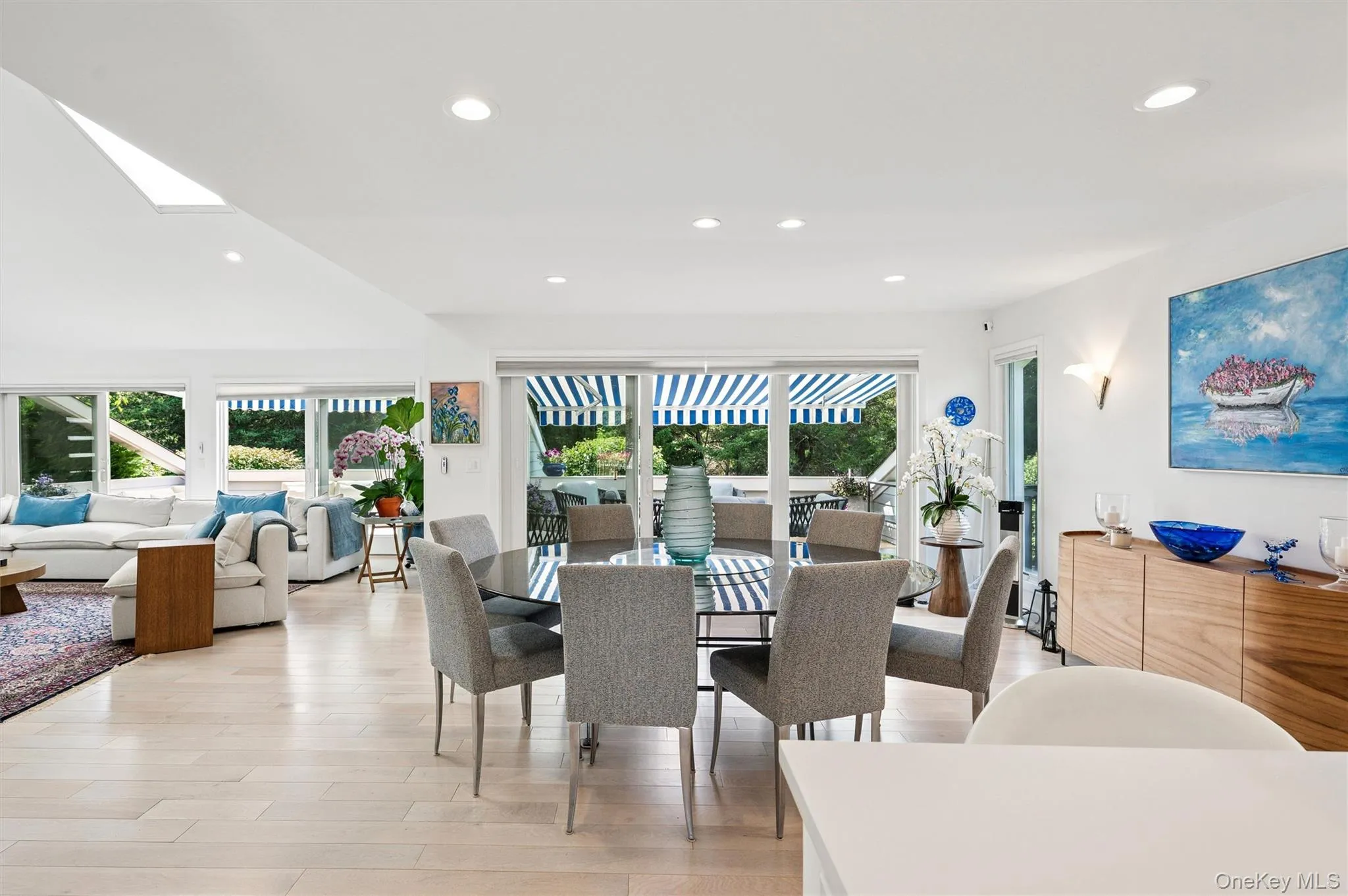 Dining room with recessed lighting, light wood finished floors, and a skylight Dining room with recessed lighting, light wood finished floors, and a skylight