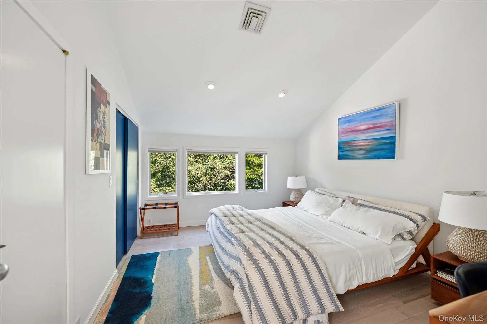 Bedroom with vaulted ceiling, wood finished floors, and recessed lighting Bedroom with vaulted ceiling, wood finished floors, and recessed lighting