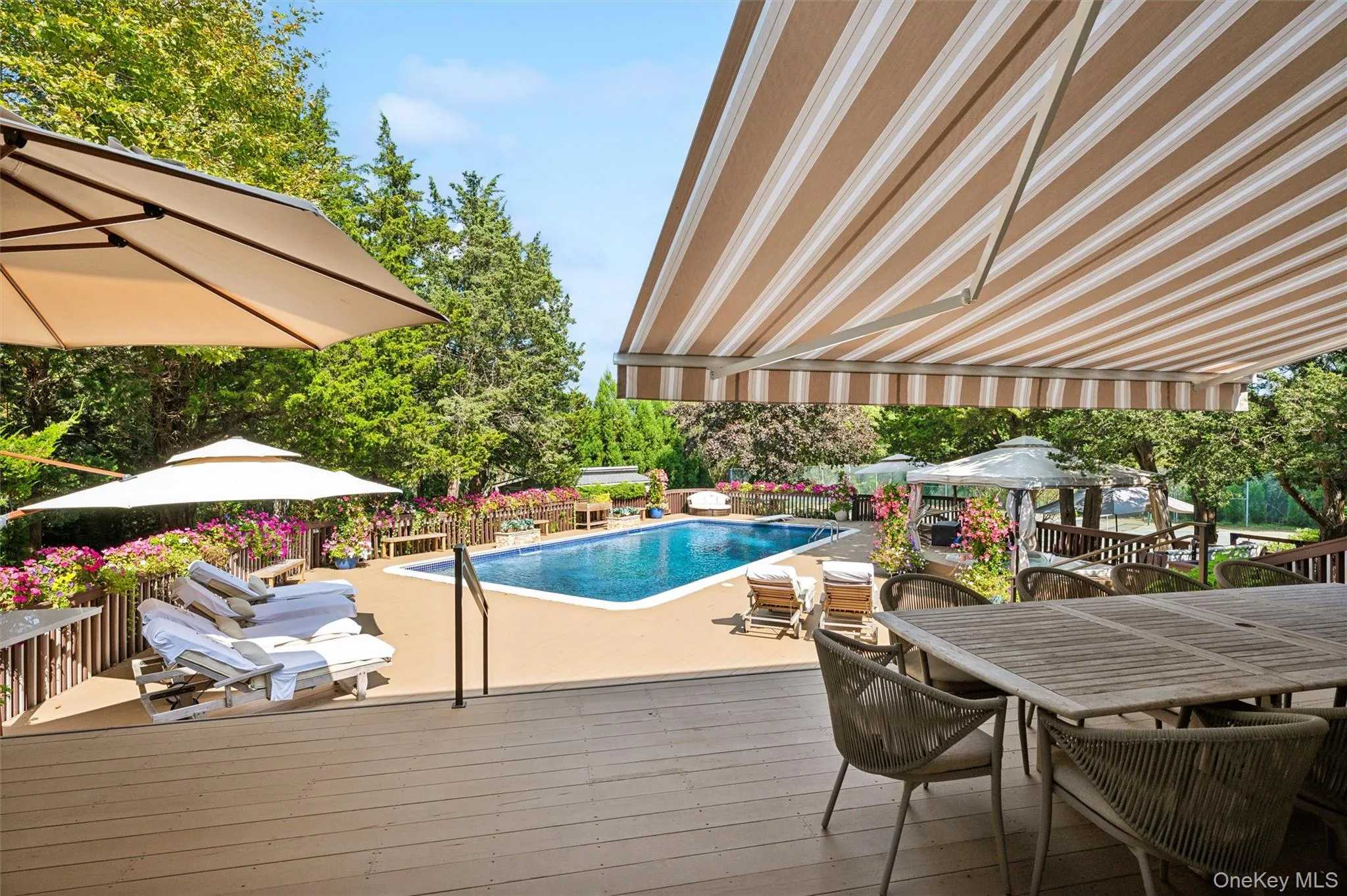 Swimming pool featuring outdoor dining space, a deck, and a patio Swimming pool featuring outdoor dining space, a deck, and a patio