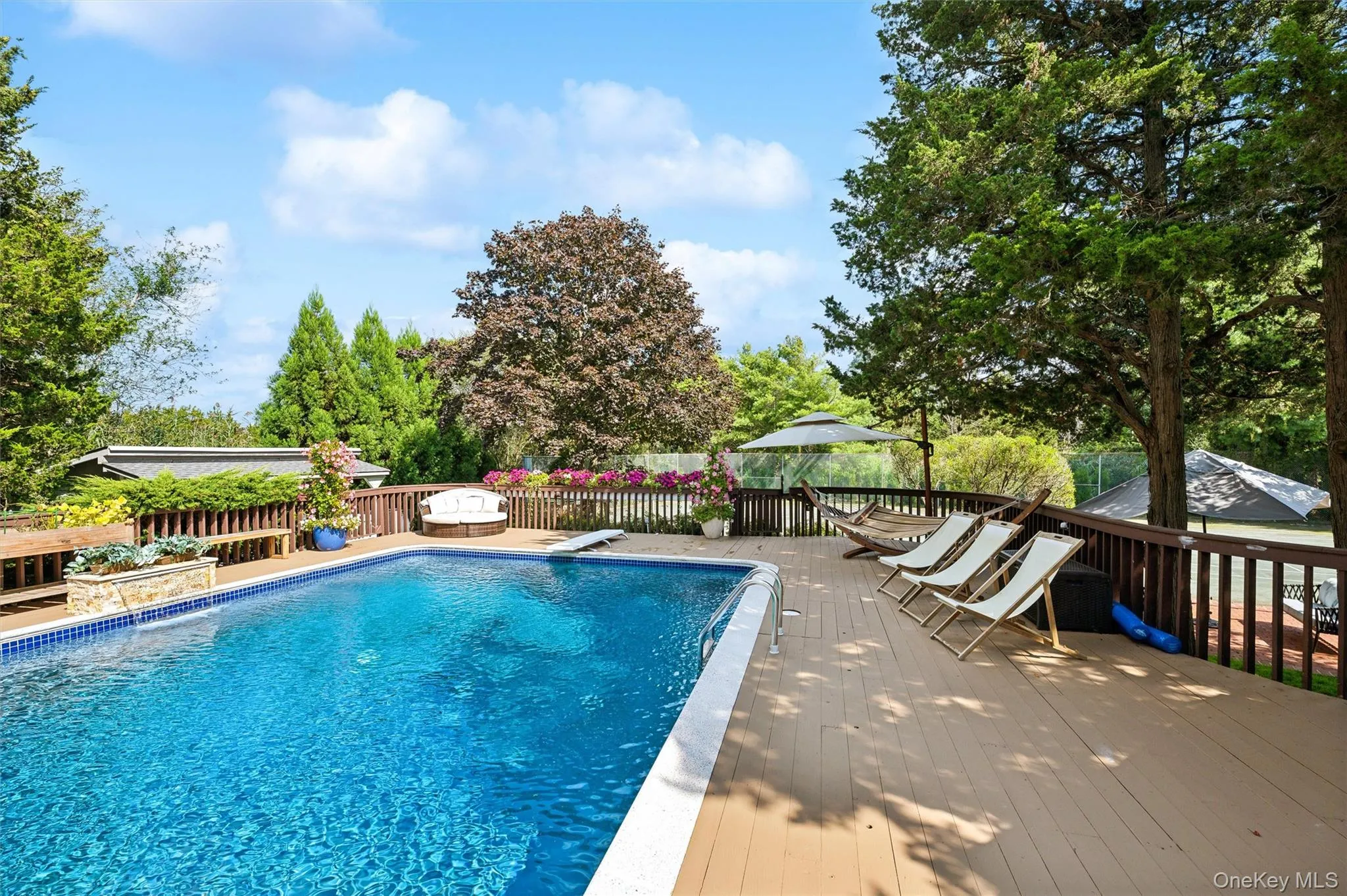 View of swimming pool with a wooden deck, a fenced backyard, a diving board, and a gazebo View of swimming pool with a wooden deck, a fenced backyard, a diving board, and a gazebo