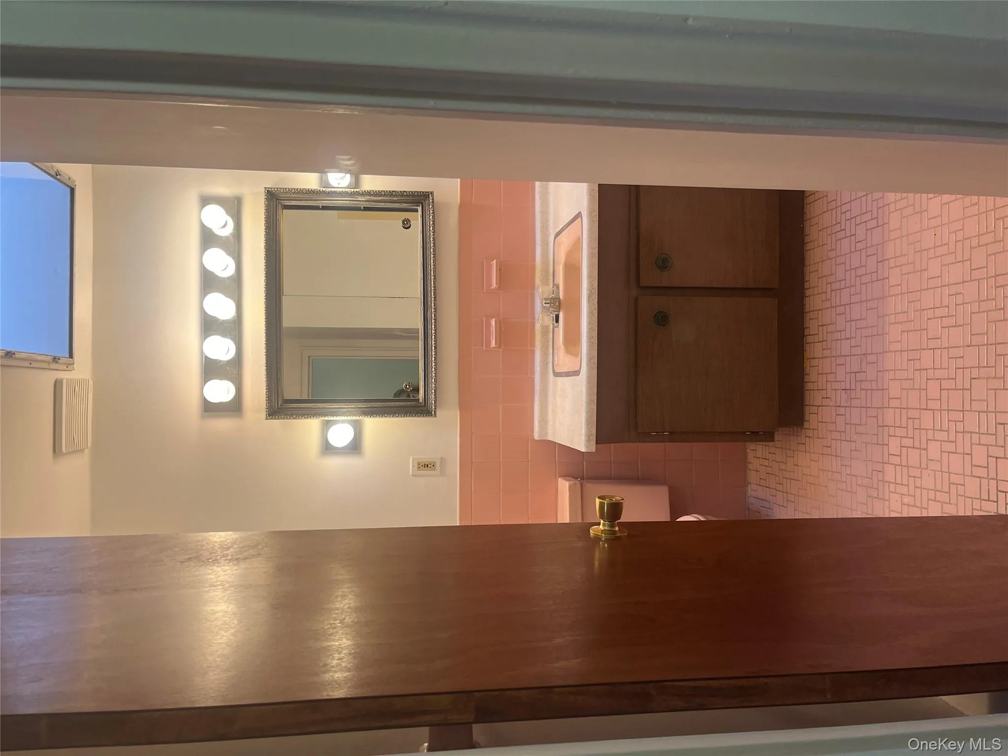 Bathroom featuring tile walls, vanity, and wainscoting Bathroom featuring tile walls, vanity, and wainscoting