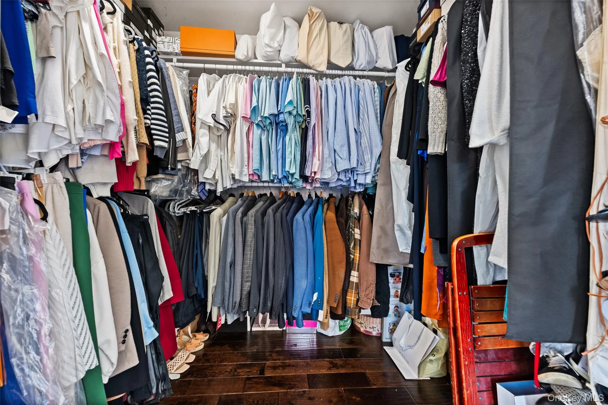Spacious closet featuring dark wood-type flooring Spacious closet featuring dark wood-type flooring