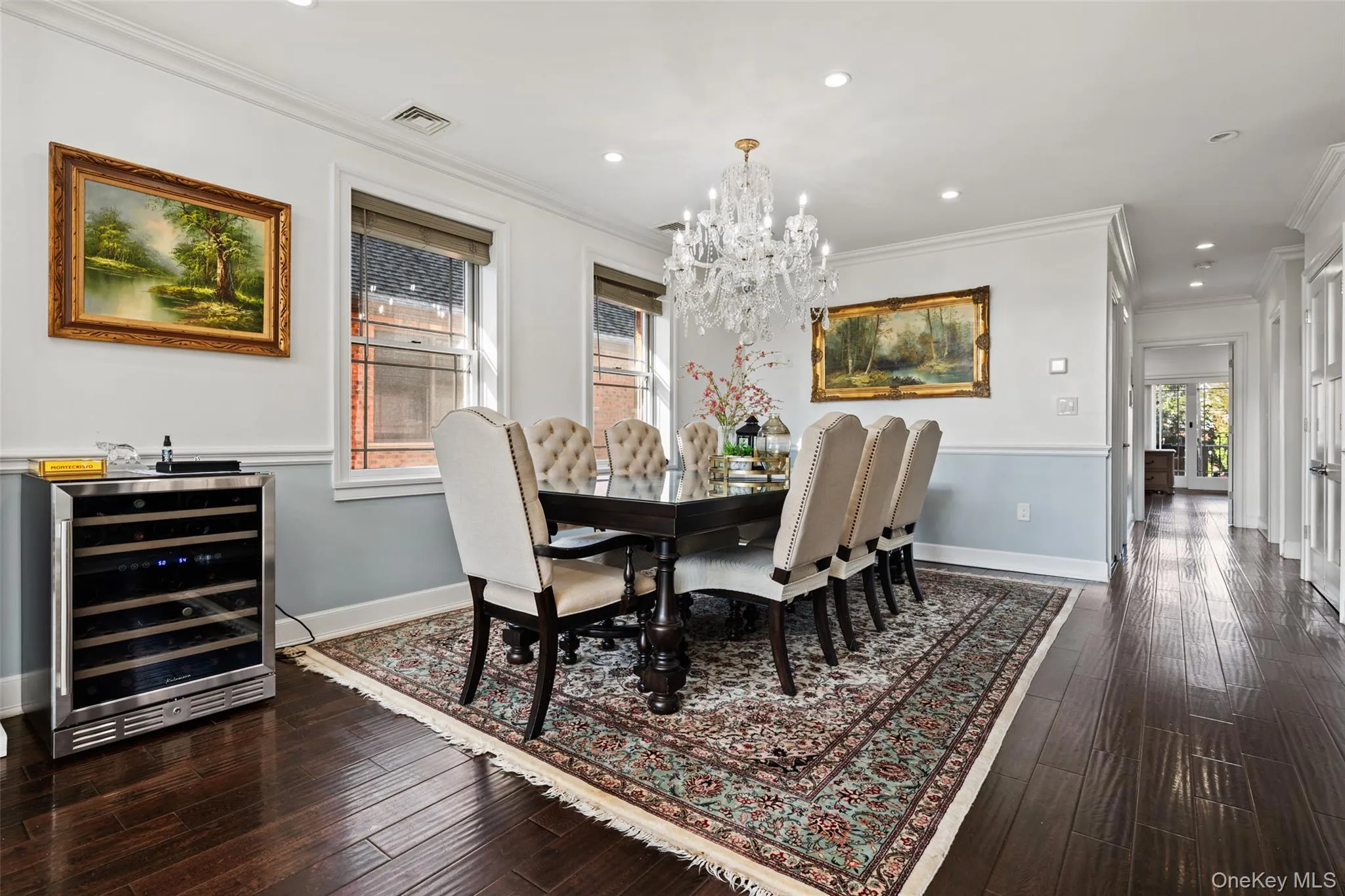 Dining area with crown molding, beverage cooler, recessed lighting, dark wood finished floors, and a chandelier Dining area with crown molding, beverage cooler, recessed lighting, dark wood finished floors, and a chandelier