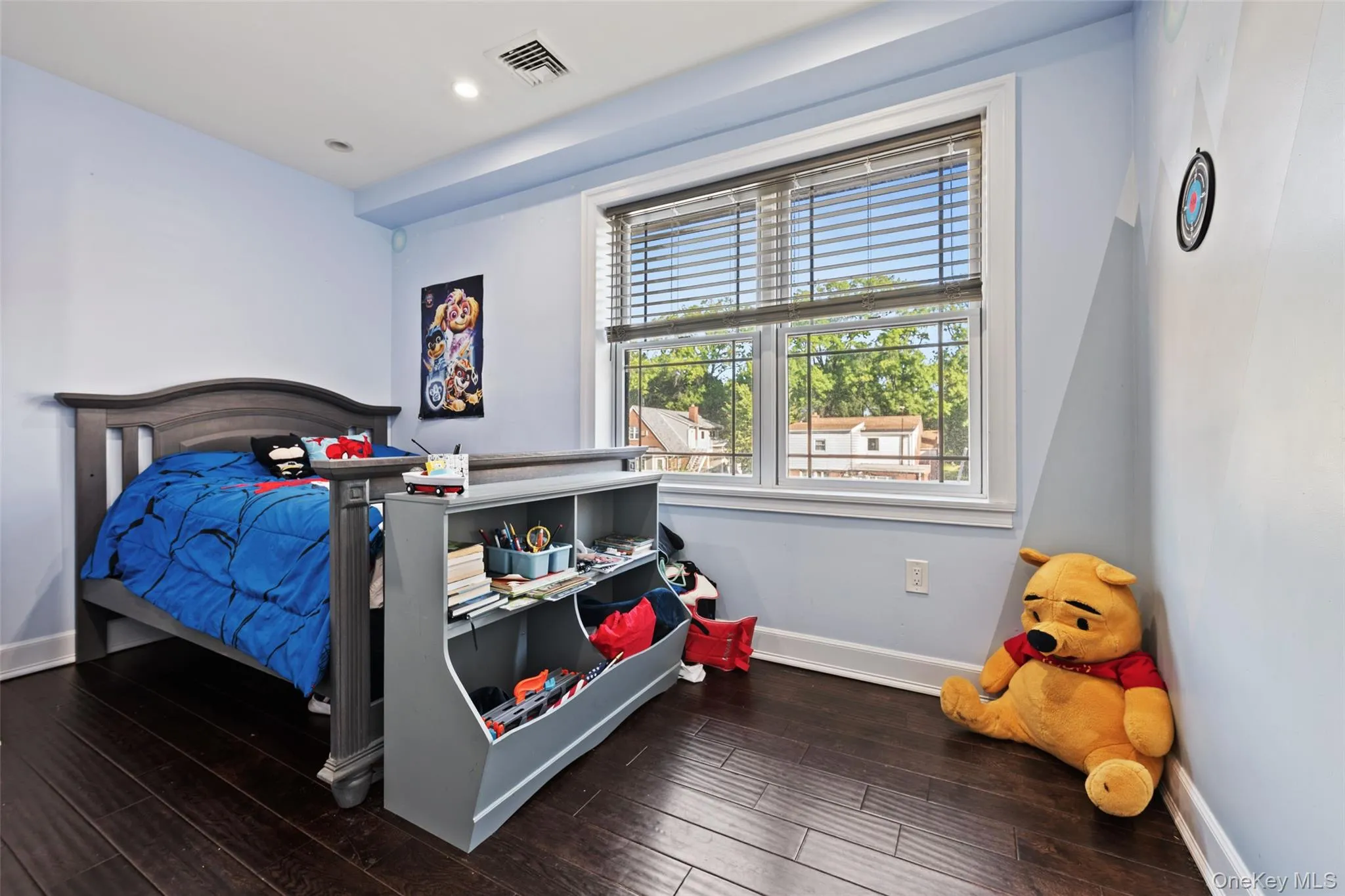 Bedroom with dark wood-style floors and recessed lighting Bedroom with dark wood-style floors and recessed lighting
