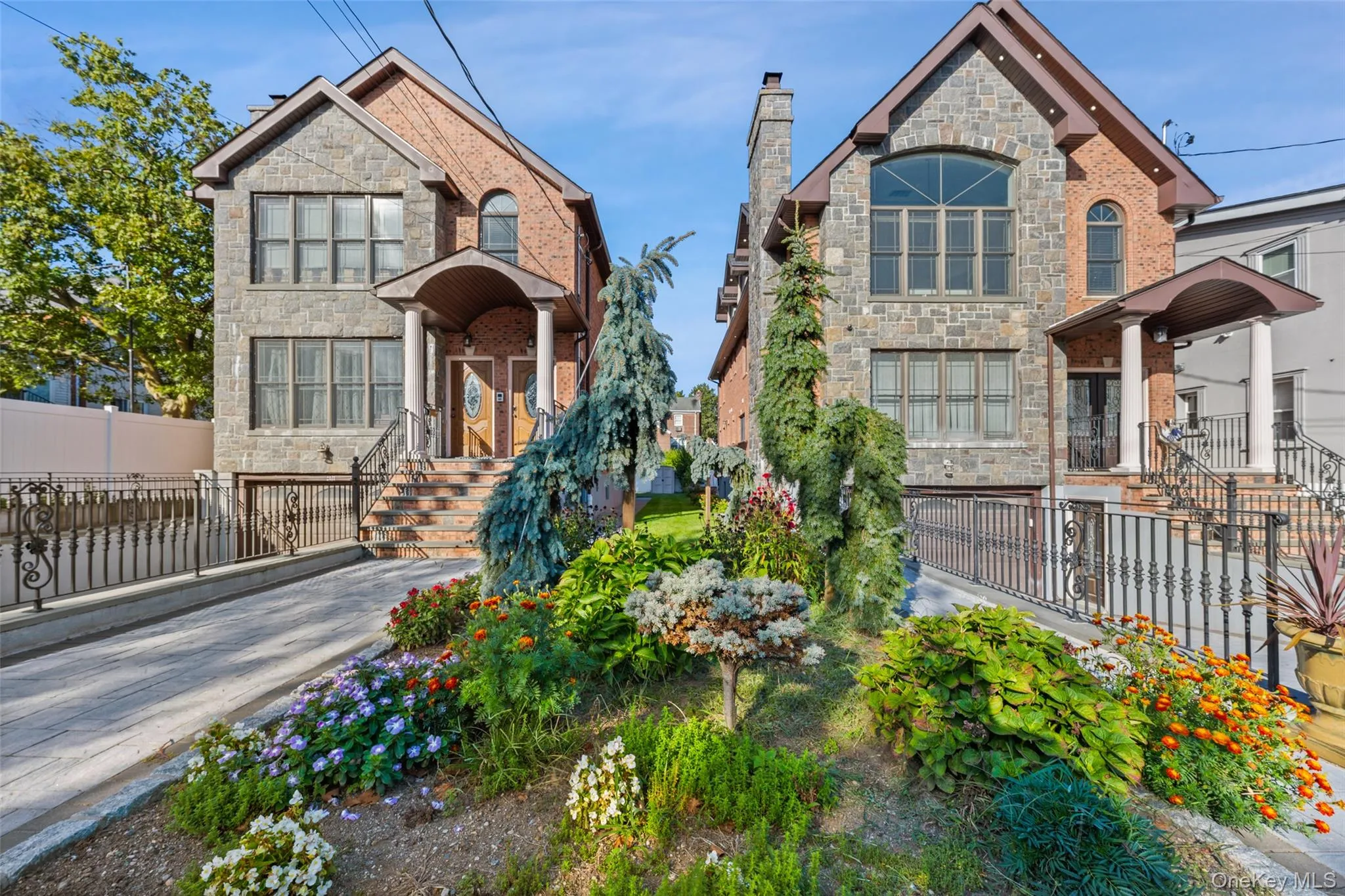 View of front of house featuring stone siding, a fenced front yard, and a chimney View of front of house featuring stone siding, a fenced front yard, and a chimney