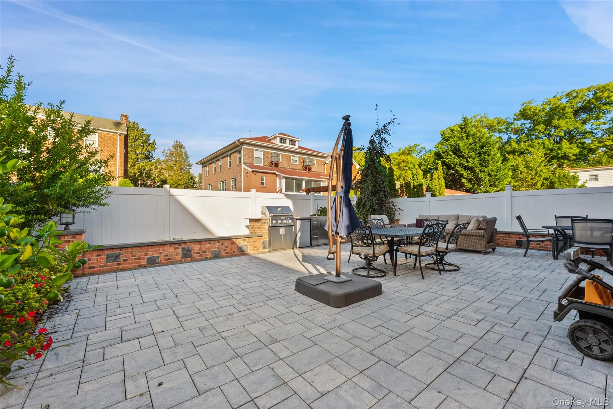 Fenced backyard with outdoor dining area and area for grilling Fenced backyard with outdoor dining area and area for grilling
