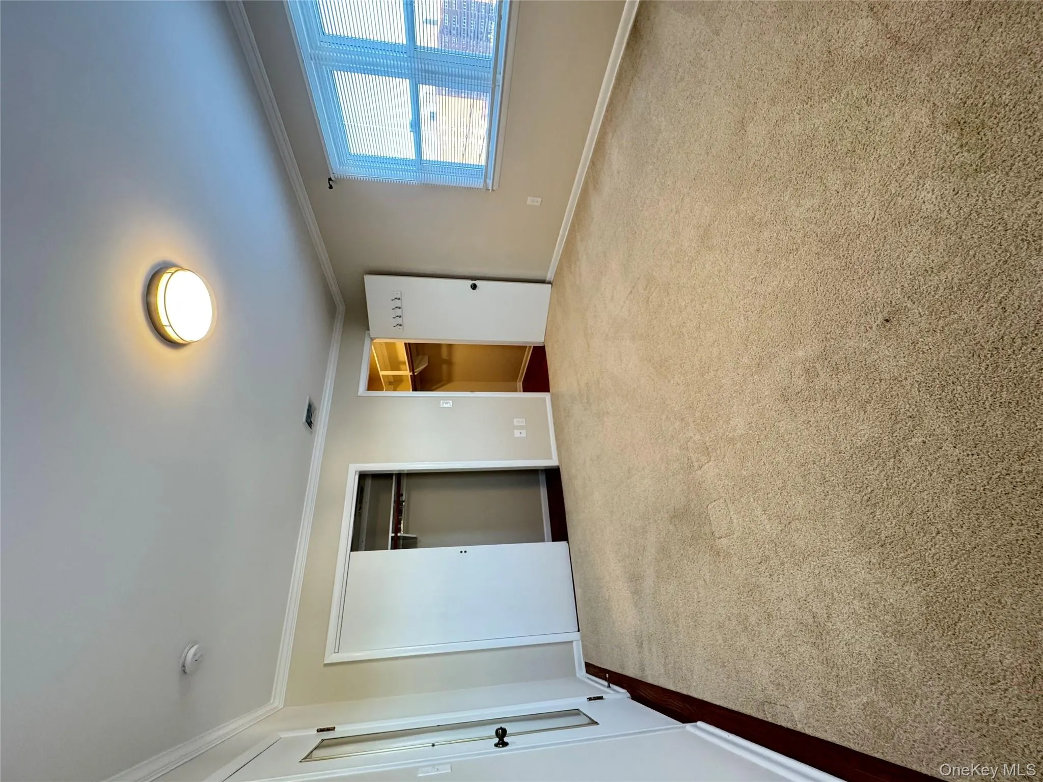 Unfurnished bedroom featuring ornamental molding and dark colored carpet Unfurnished bedroom featuring ornamental molding and dark colored carpet