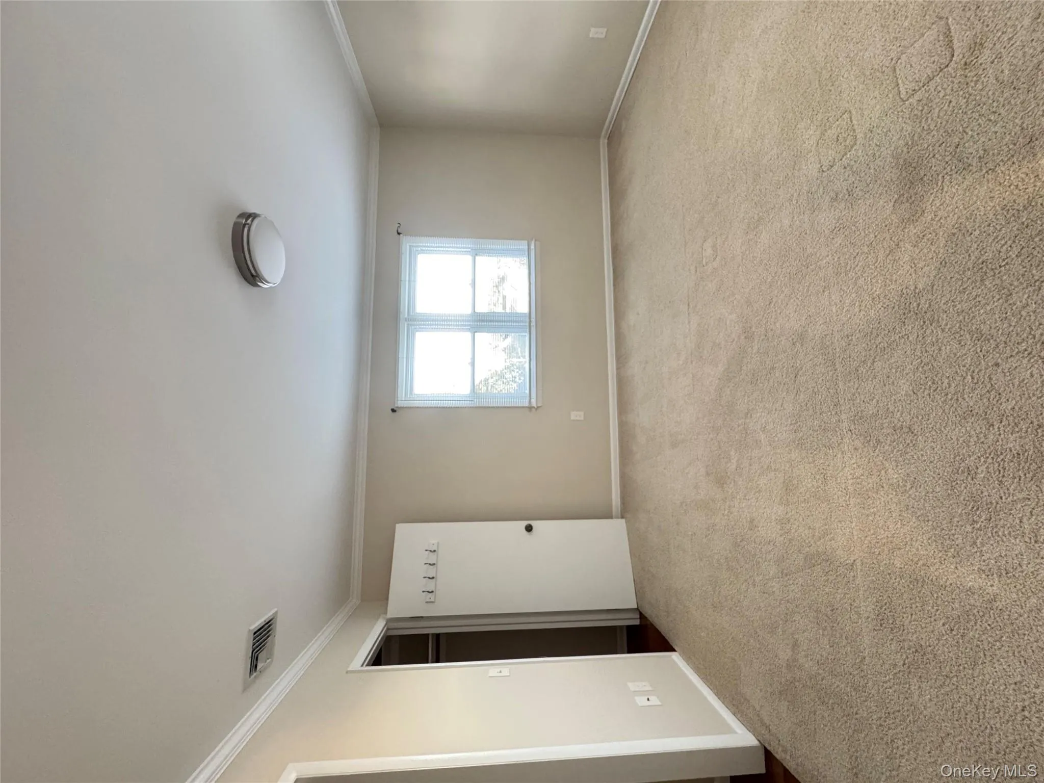 Unfurnished bedroom featuring ornamental molding and light colored carpet Unfurnished bedroom featuring ornamental molding and light colored carpet