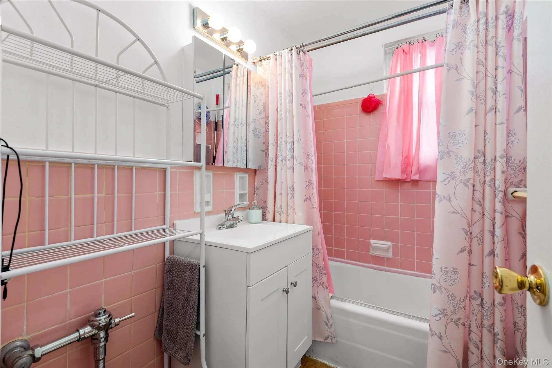 Full bath with shower / bath combo with shower curtain, vanity, and tile walls Full bath with shower / bath combo with shower curtain, vanity, and tile walls