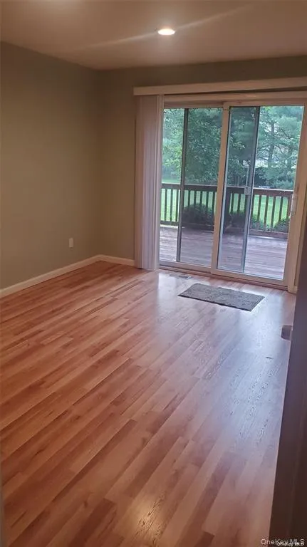 Empty room with light wood finished floors and recessed lighting Empty room with light wood finished floors and recessed lighting