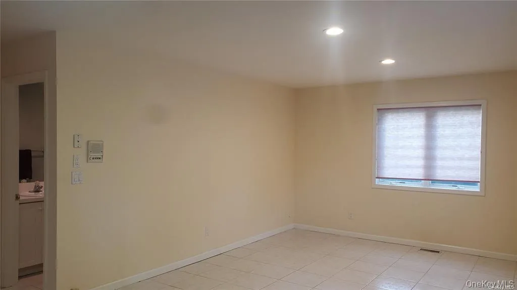 Spare room with recessed lighting and light tile patterned floors Spare room with recessed lighting and light tile patterned floors