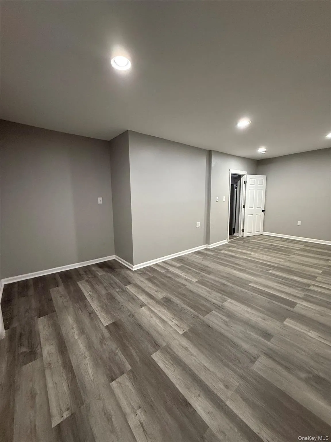 Basement with recessed lighting and wood finished floors Basement with recessed lighting and wood finished floors