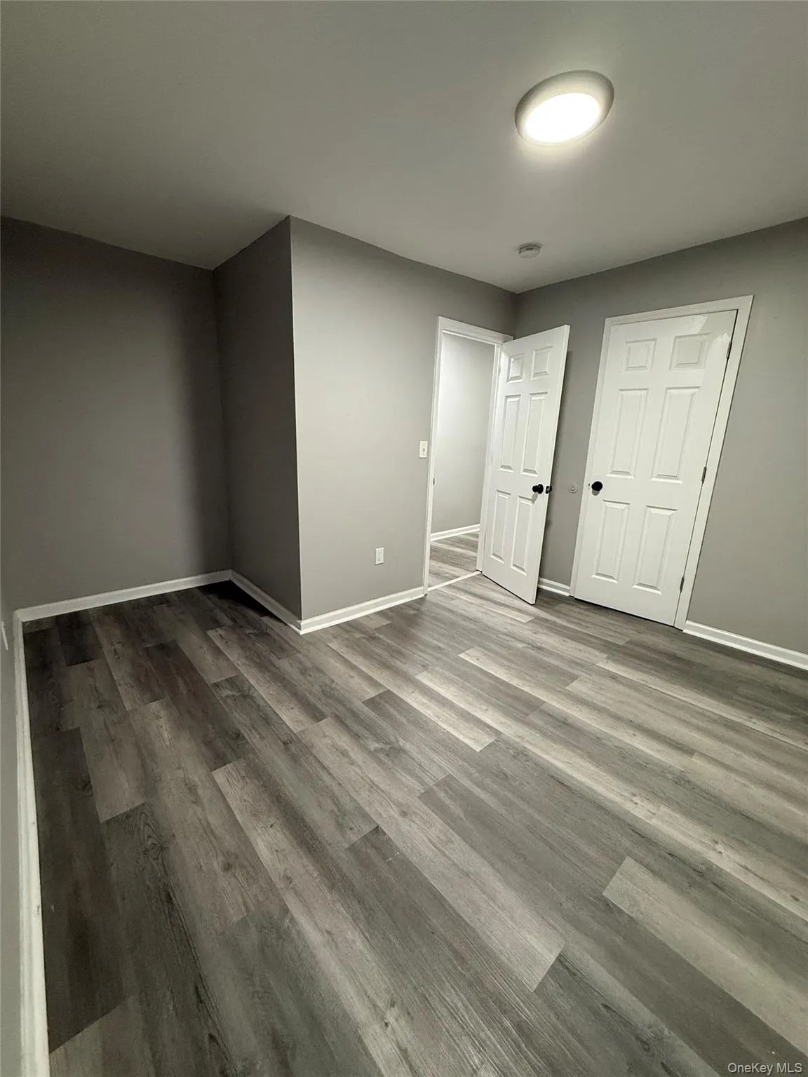 Unfurnished bedroom with baseboards and wood finished floors Unfurnished bedroom with baseboards and wood finished floors