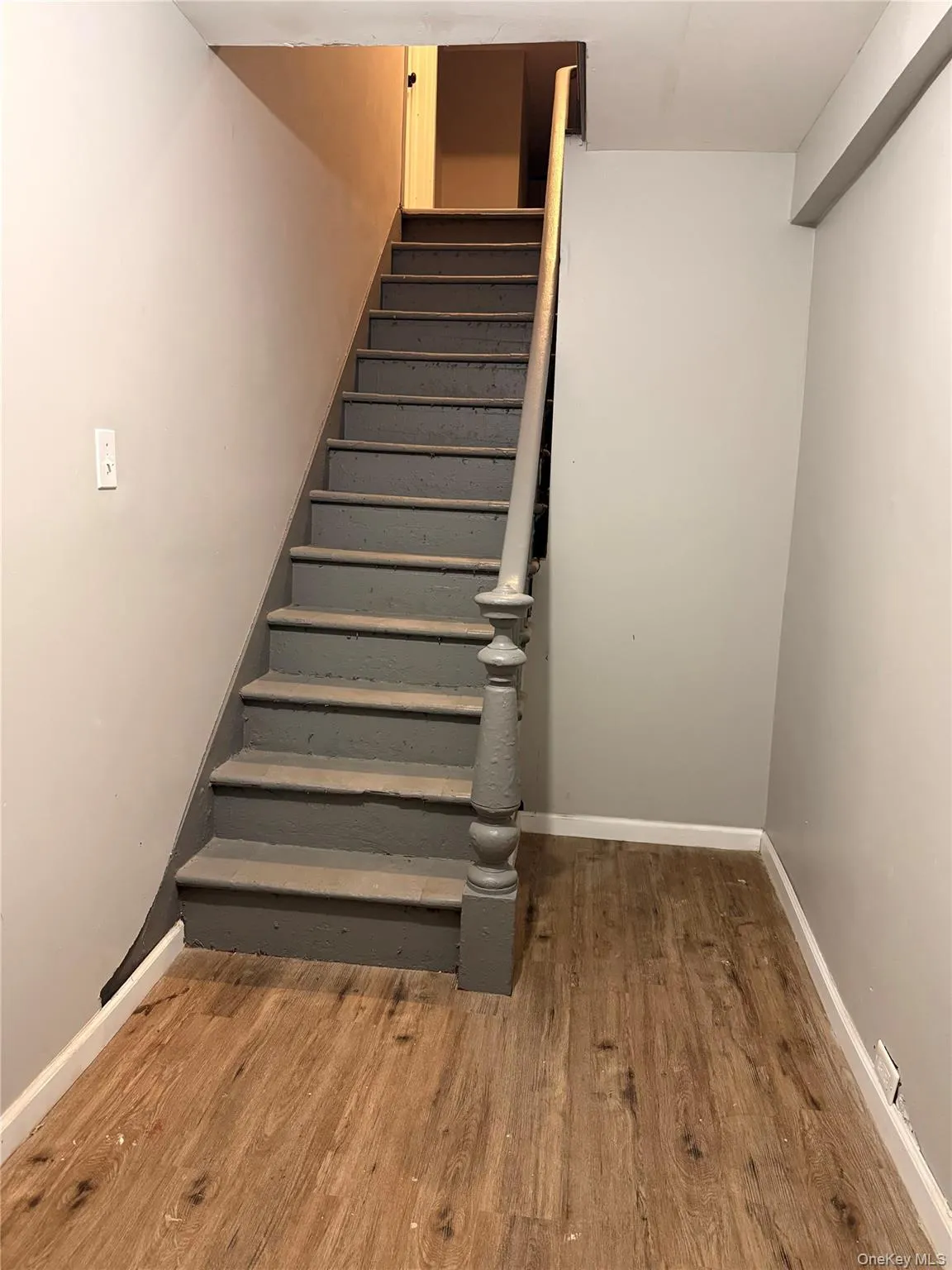 Stairway featuring wood finished floors and baseboards Stairway featuring wood finished floors and baseboards