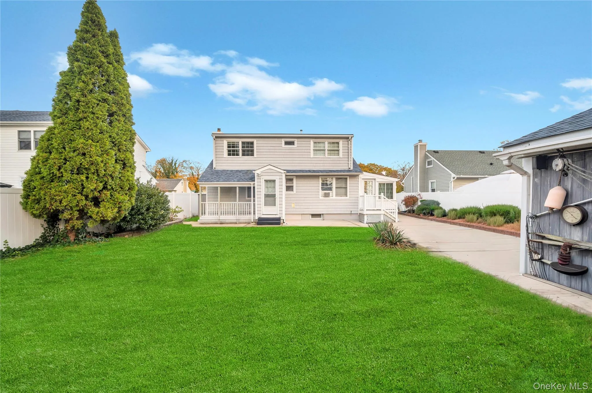 Back of property with a fenced backyard and entry steps Back of property with a fenced backyard and entry steps