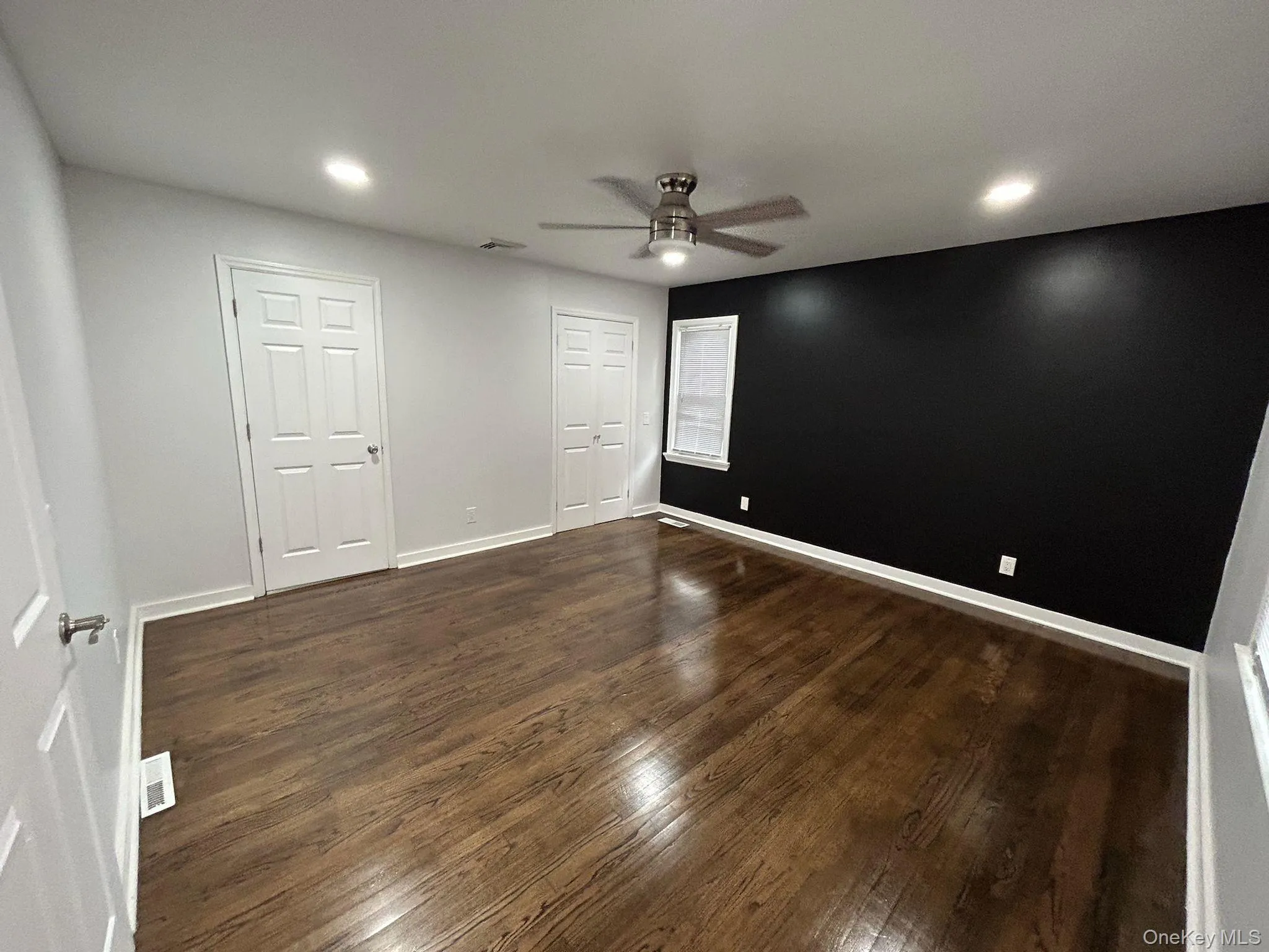 Unfurnished bedroom featuring dark wood finished floors, ceiling fan, recessed lighting, and a closet Unfurnished bedroom featuring dark wood finished floors, ceiling fan, recessed lighting, and a closet