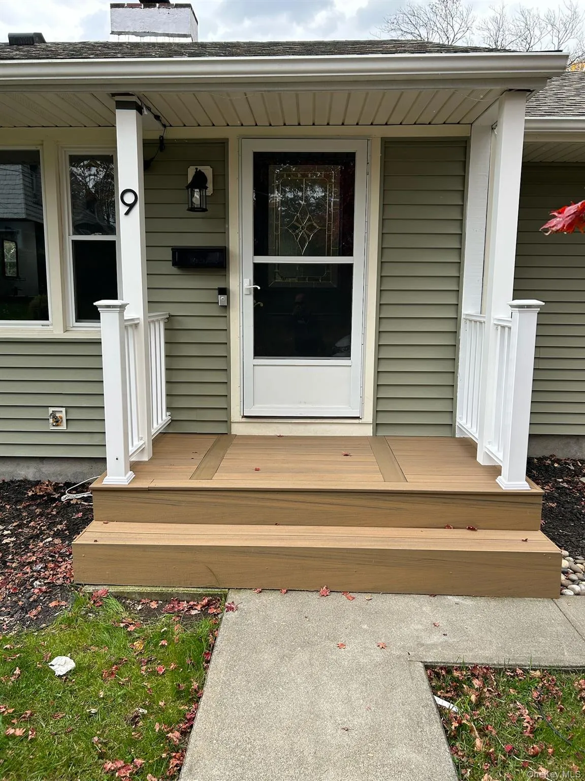 Entrance to property with a chimney, a shingled roof, and a deck Entrance to property with a chimney, a shingled roof, and a deck