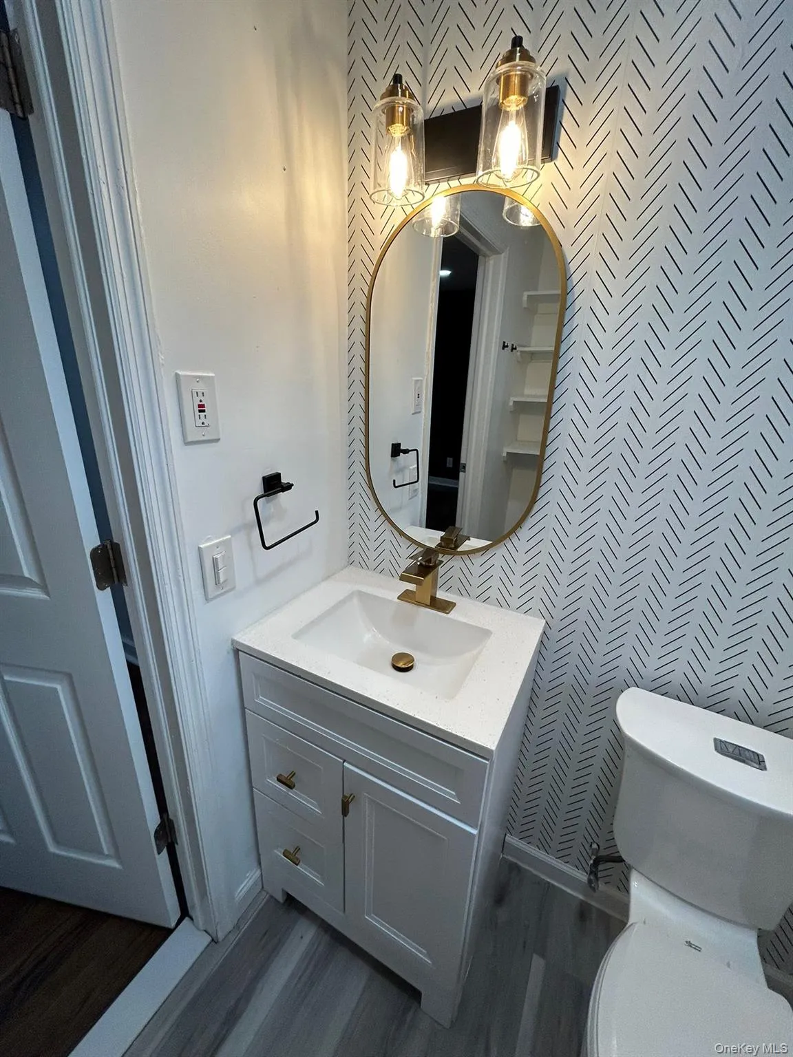 Bathroom with vanity and dark wood-style floors Bathroom with vanity and dark wood-style floors