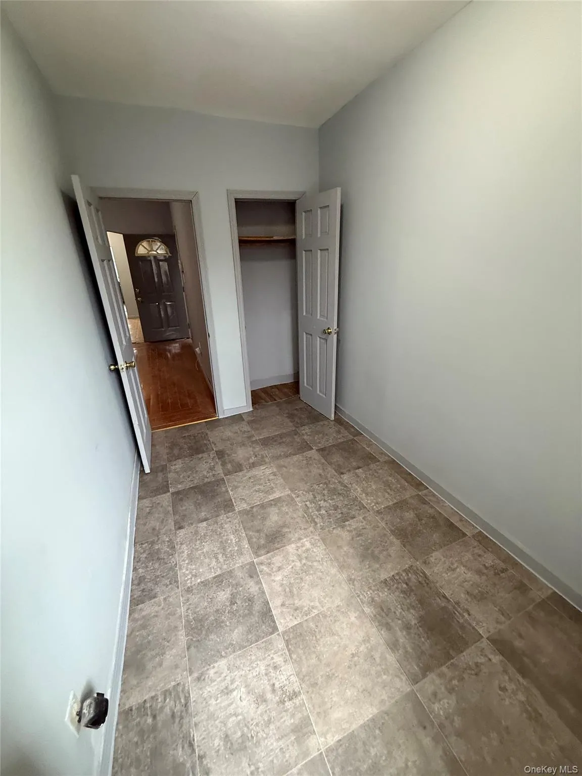 Unfurnished bedroom featuring a closet and stone finish floors Unfurnished bedroom featuring a closet and stone finish floors